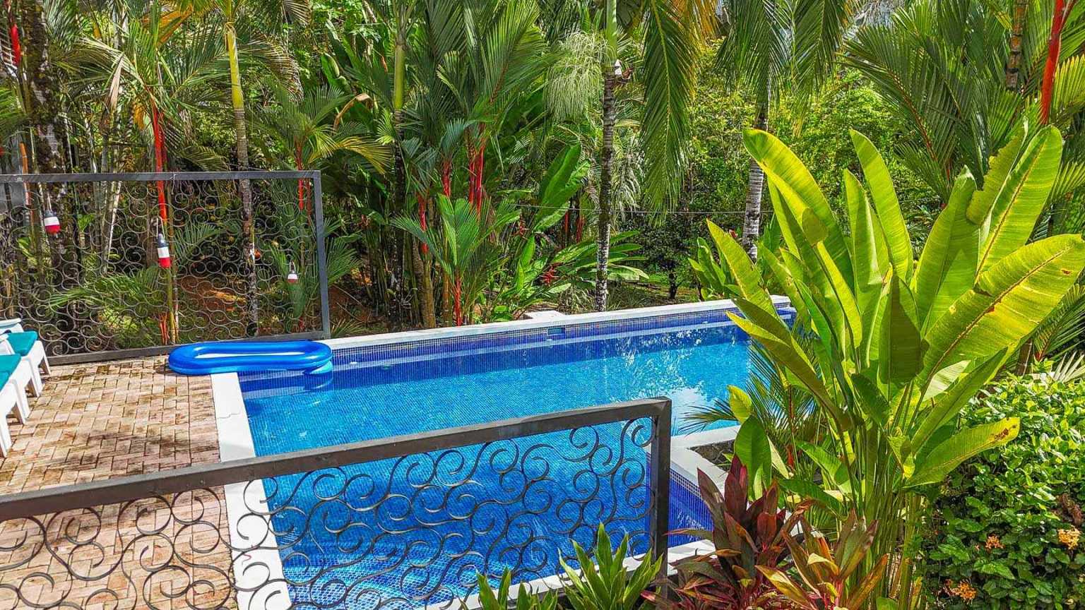 42517 (10) Beautiful Half-Acre Property in the Heart of Ojochal with Mountain Views, Traditional Homes, Pool, Lush Mature Gardens Priced to Sell in Ojochal Costa Rica