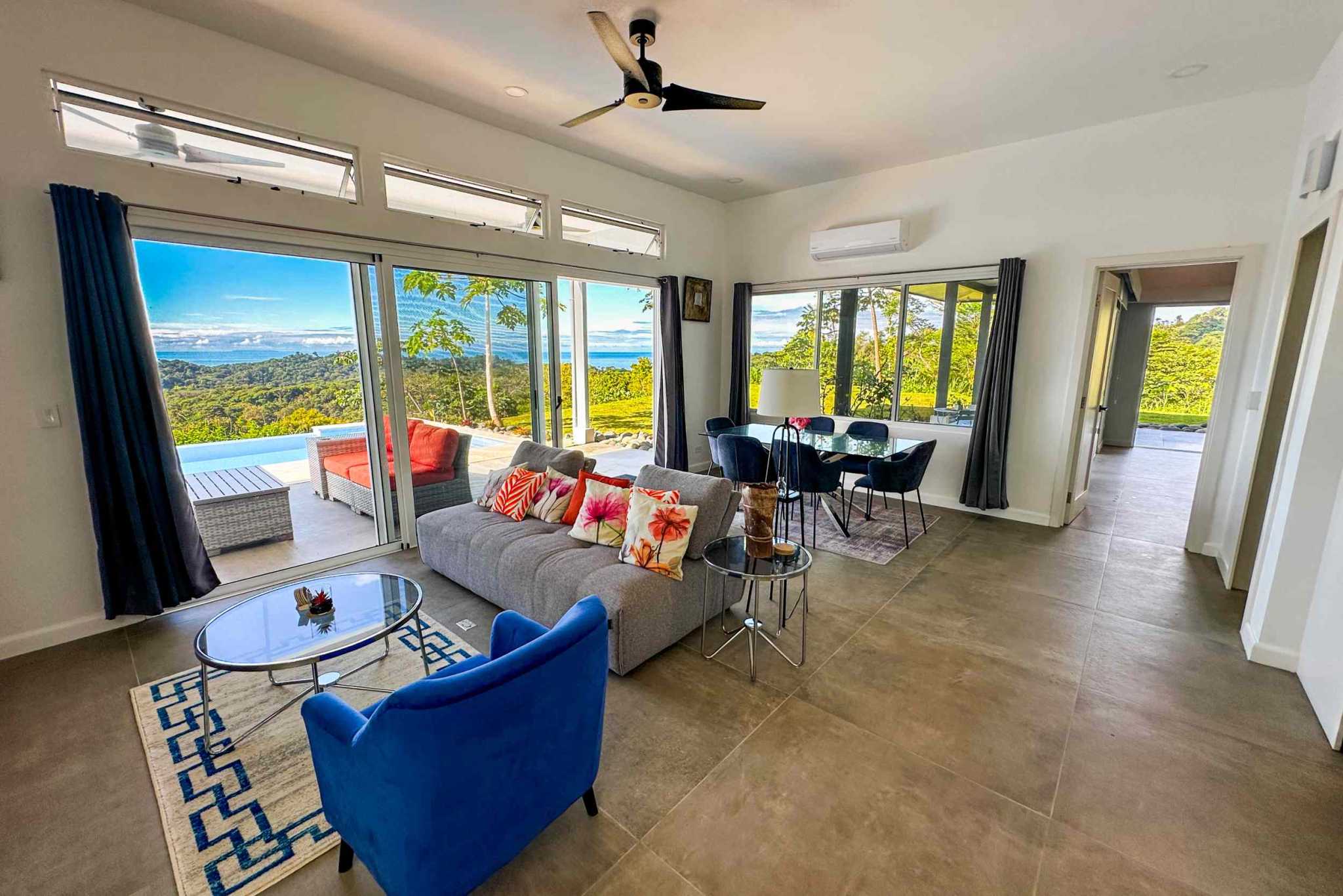 Mountain & Ocean View Retreat living and dining area with pool, jungle, and ocean views in Ojochal, Costa Rica
