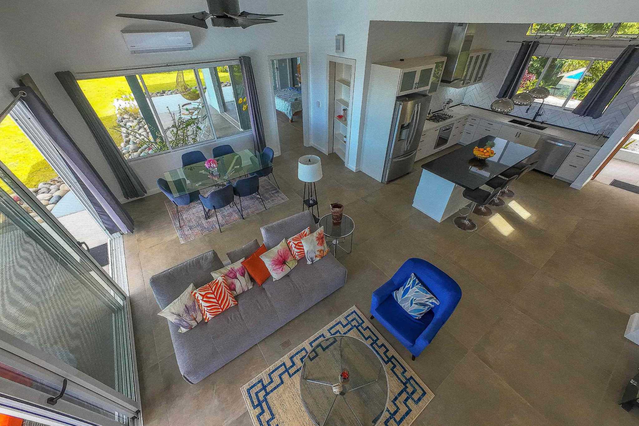 Luxury Mountain Ocean View Home open-concept living, dining, and kitchen area with colorful decor in Ojochal, Costa Rica