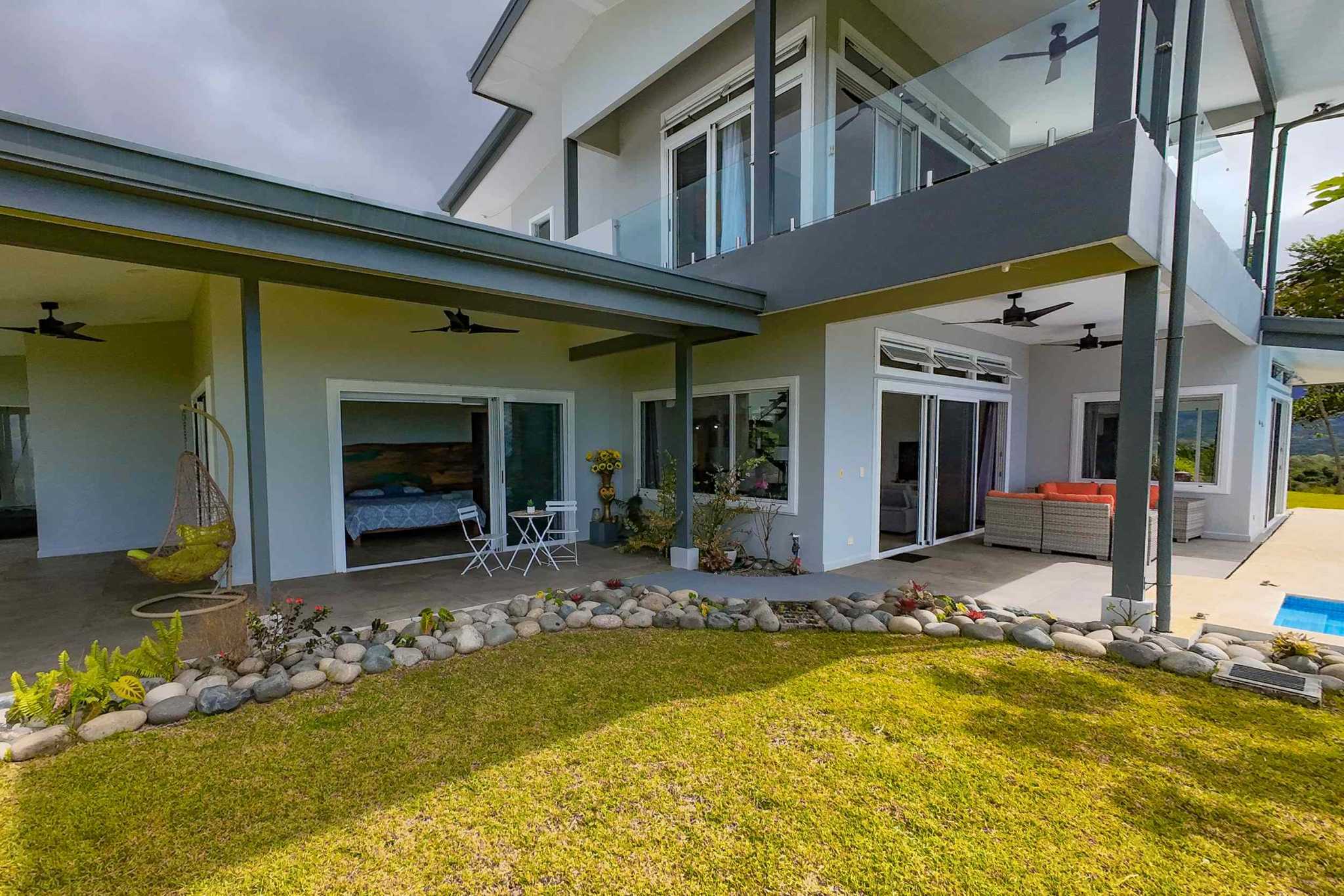 Mountain & Ocean View Home covered patio, balcony, and landscaped backyard in Ojochal, Costa Rica