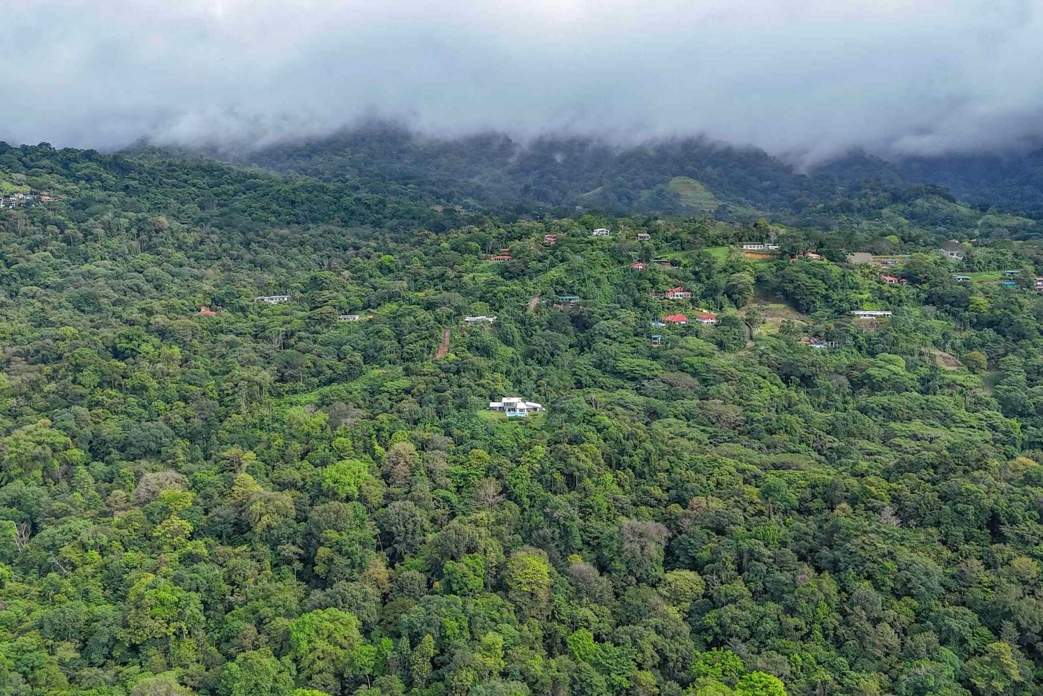 Mountain Retreat aerial view over lush rainforest canopy and misty mountains in Ojochal, Costa Rica