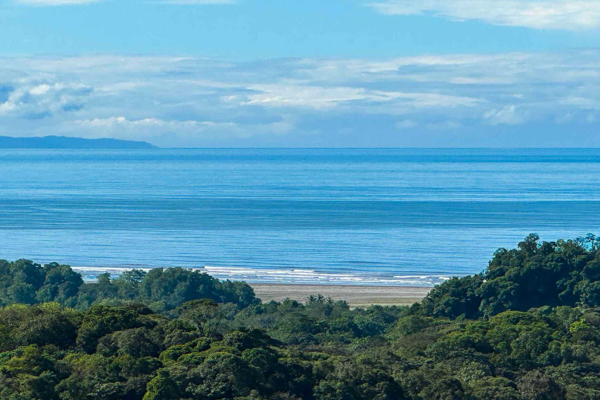 Luxury Retreat ocean and beach view over treetops in Ojochal, Costa Rica