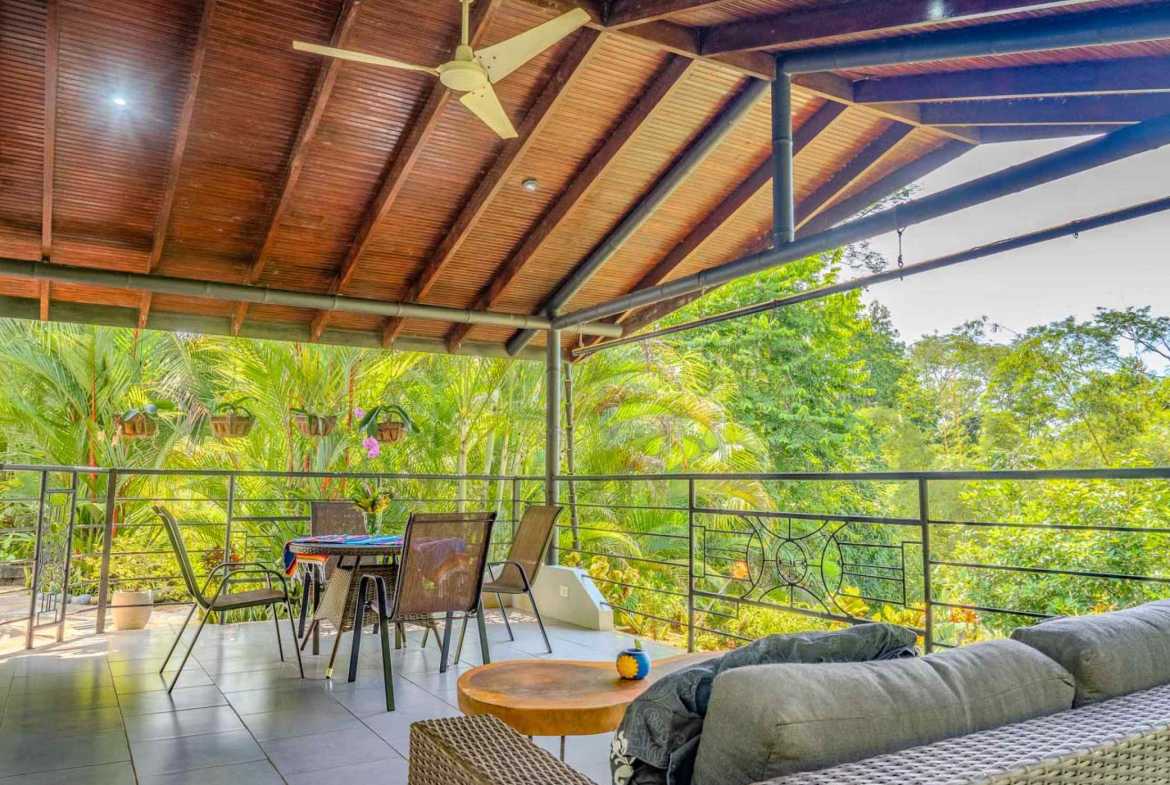 River & Waterfall Home covered terrace with wicker furniture and jungle view in Ojochal, Costa Rica