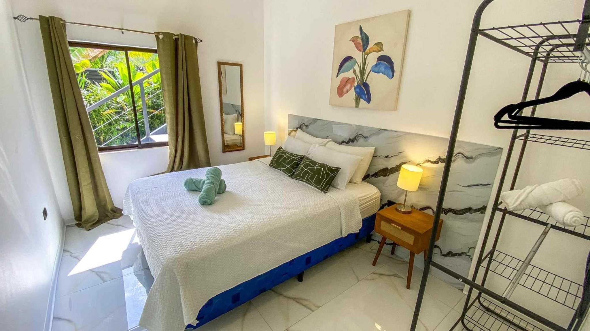 55856-16 3-Bedroom Home with Pool: bright bedroom with double bed, marble-look headboard and tropical garden window in Bahia, Costa Rica