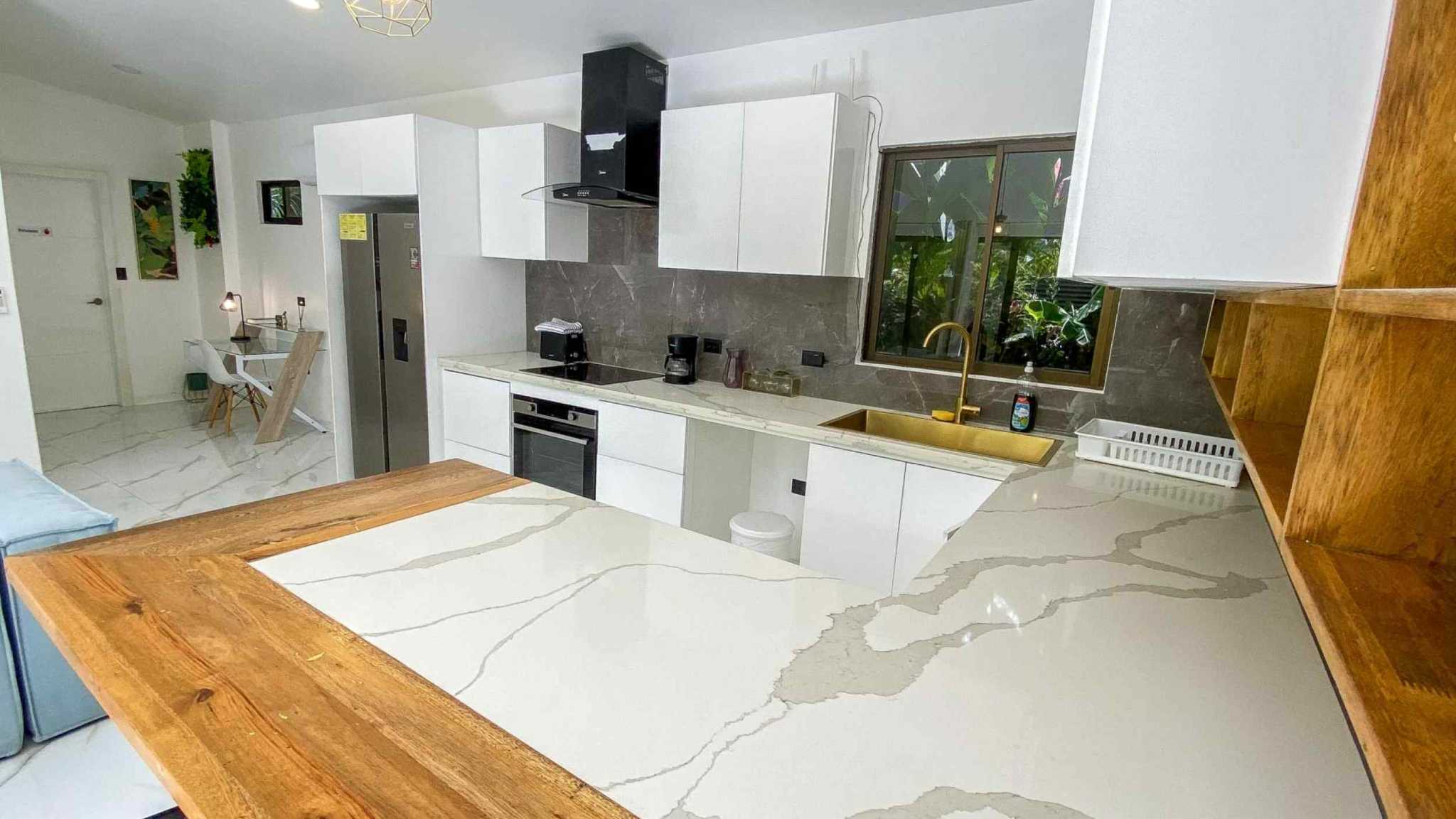 55856-13 3-Bedroom Home with Pool: modern white kitchen, quartz counters, gold sink and wood bar in Bahia, Costa Rica