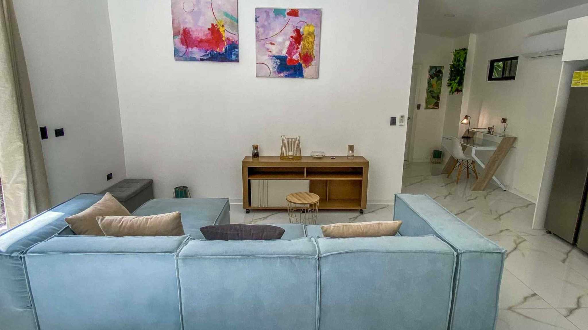 55856-6 3-Bedroom Home with Pool: blue sectional sofa, abstract art and marble-look tile floors in living room in Bahia, Costa Rica