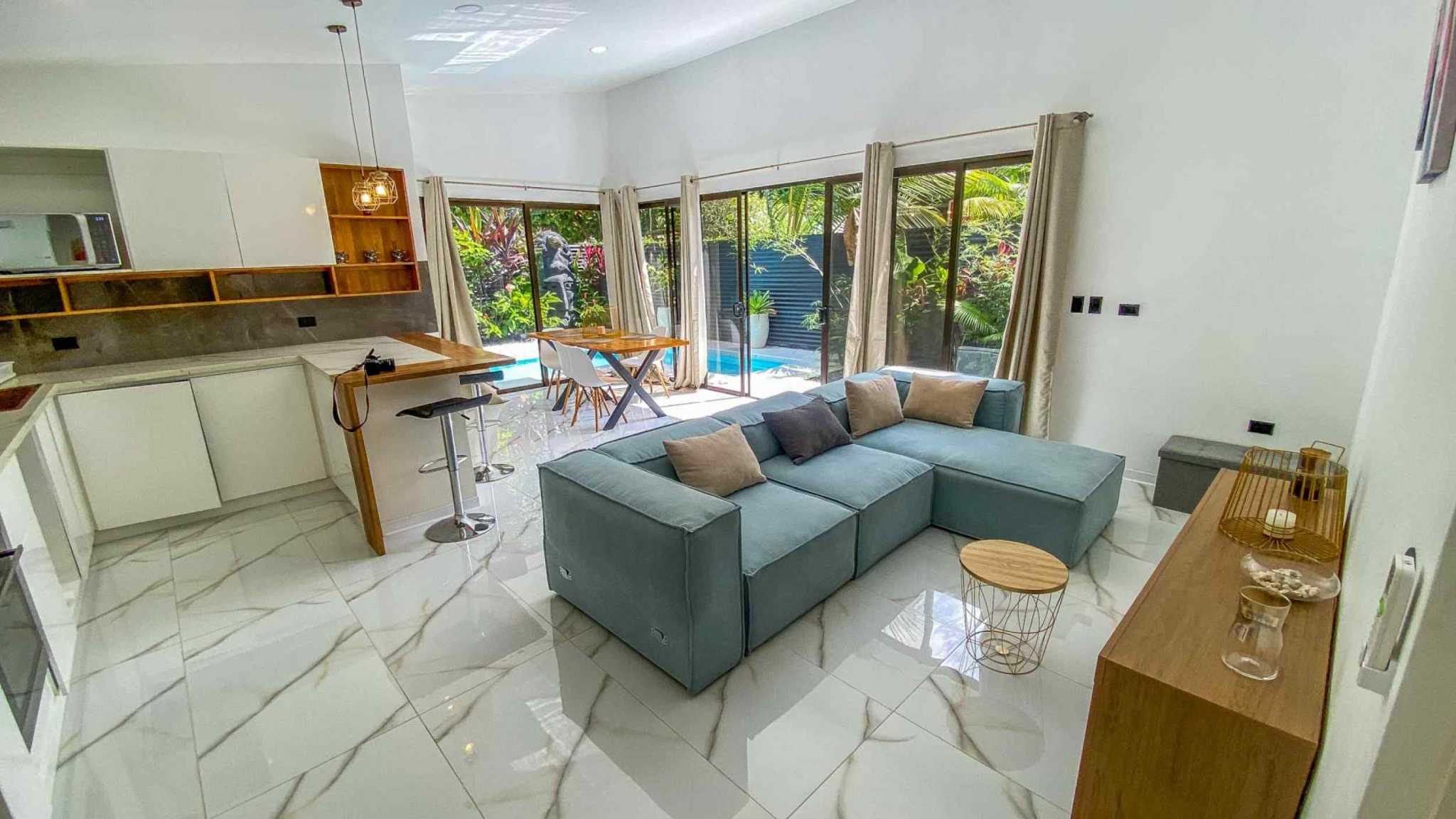 55856-3 3-Bedroom Home with Pool: open living area, kitchen, blue sofa and sliding doors to pool in Bahia, Costa Rica
