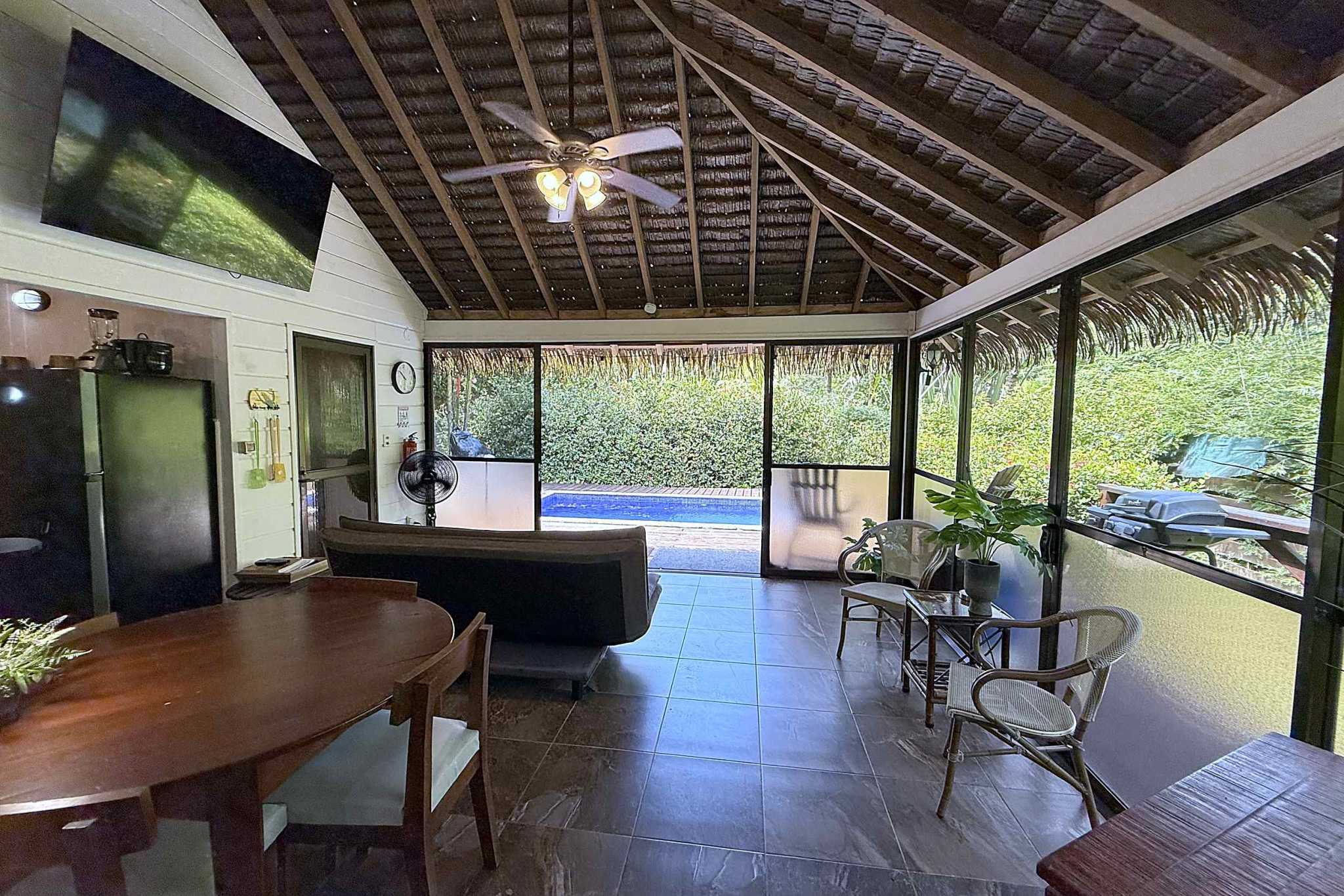 65486-06 Jungle Sanctuary Villa open-air living and dining area with pool and jungle view in Ojochal, Costa Rica