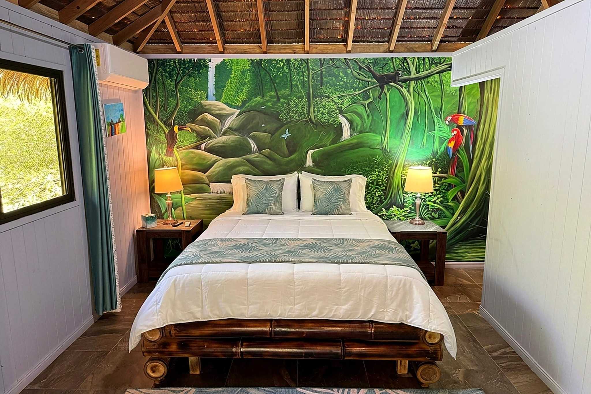 65486-17 Jungle Sanctuary bedroom with bamboo bed and painted jungle mural of toucans and parrots in Ojochal, Costa Rica
