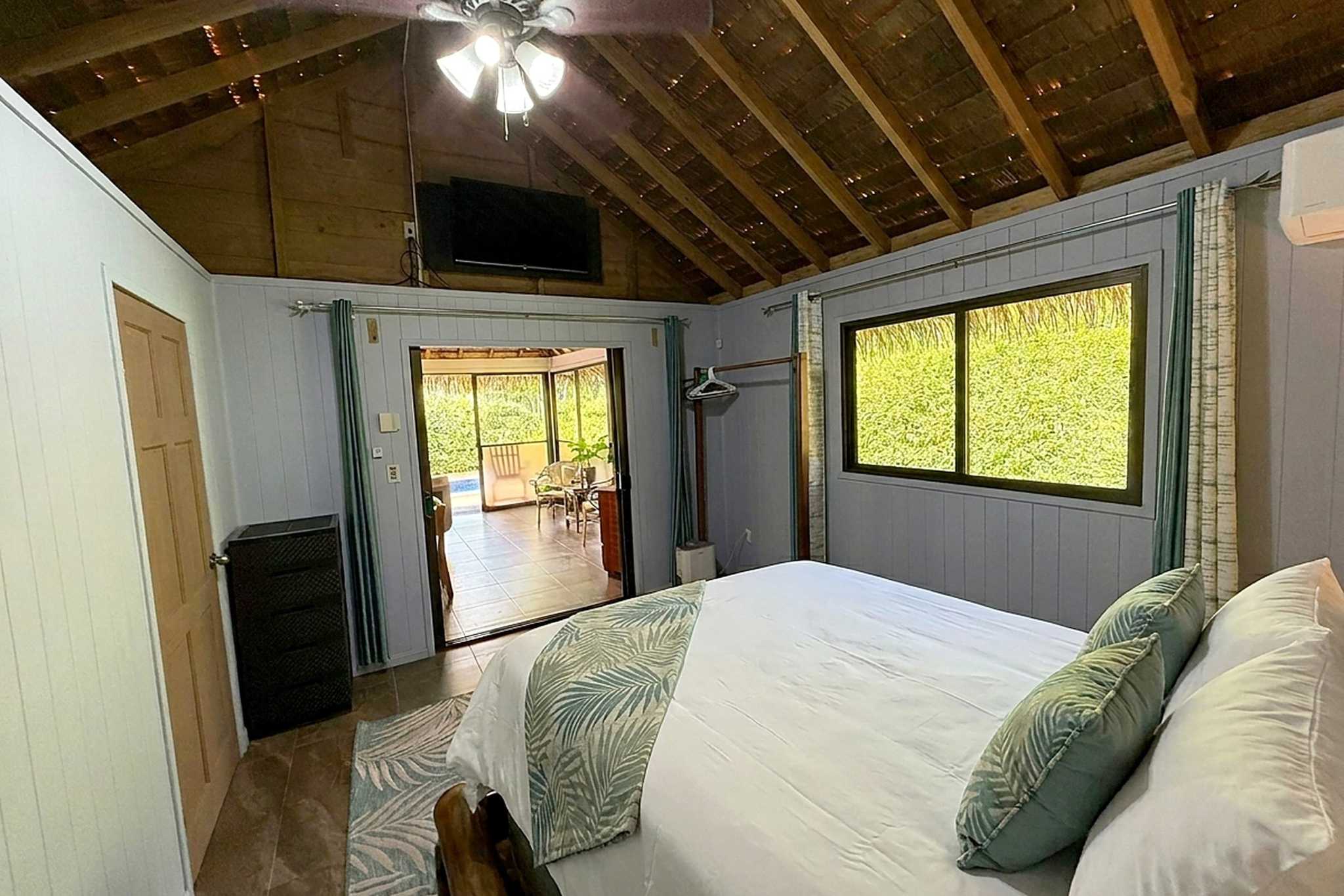 65486-20 Jungle Sanctuary bedroom with thatched ceiling and jungle-view window in Ojochal, Costa Rica