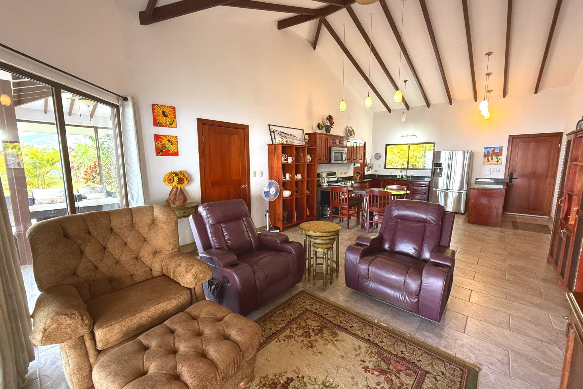 Spacious Living Room Living room with leather recliners, vaulted ceiling, and glass doors opening to the terrace in Toucan Valley.