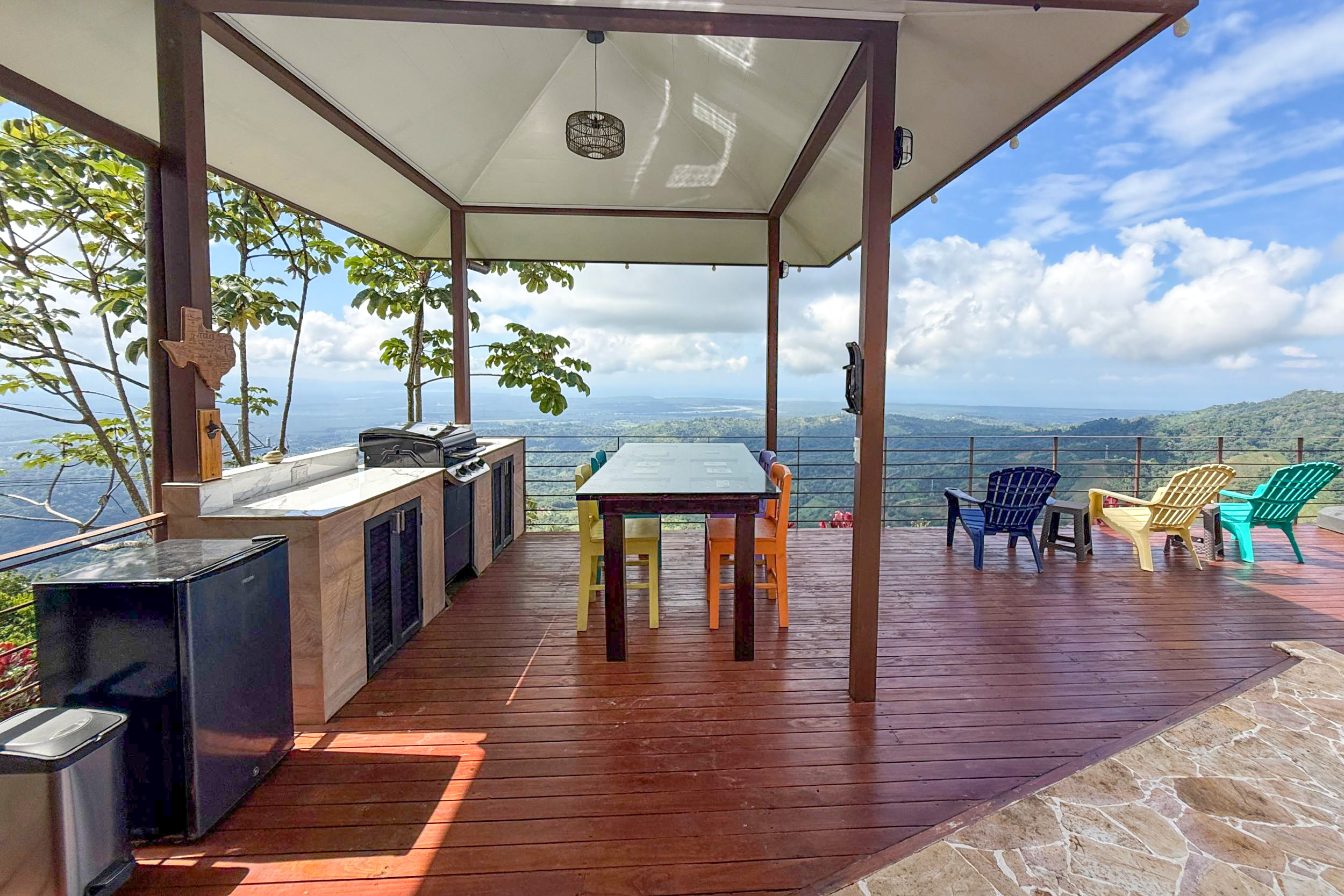 Outdoor kitchen and covered dining patio with panoramic ocean views in Toucan Valley, Costa Rica.