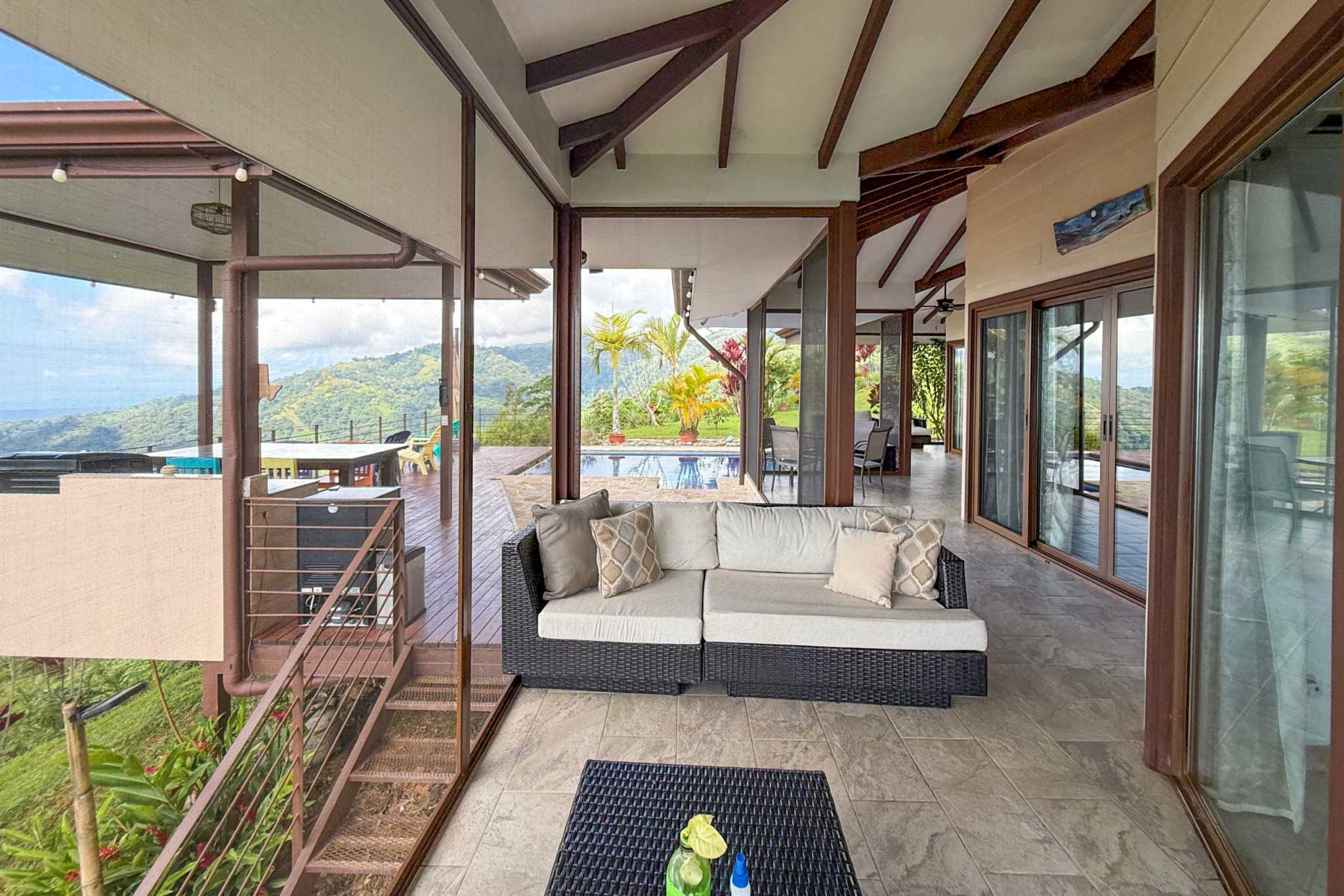 Covered Patio & Lounge Covered patio with outdoor seating overlooking the pool and mountains in Toucan Valley, Costa Rica.