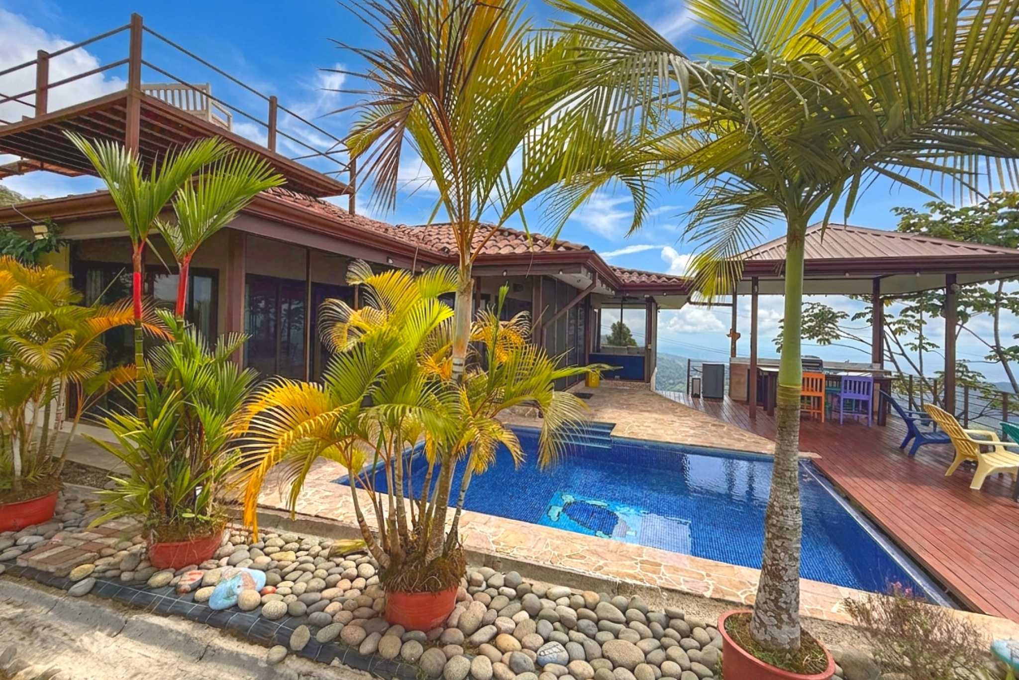 Swimming Pool & Deck Ocean-View 3-Bedroom Home swimming pool and palm trees in Toucan Valley/Osa Mountain Village, Costa Rica
