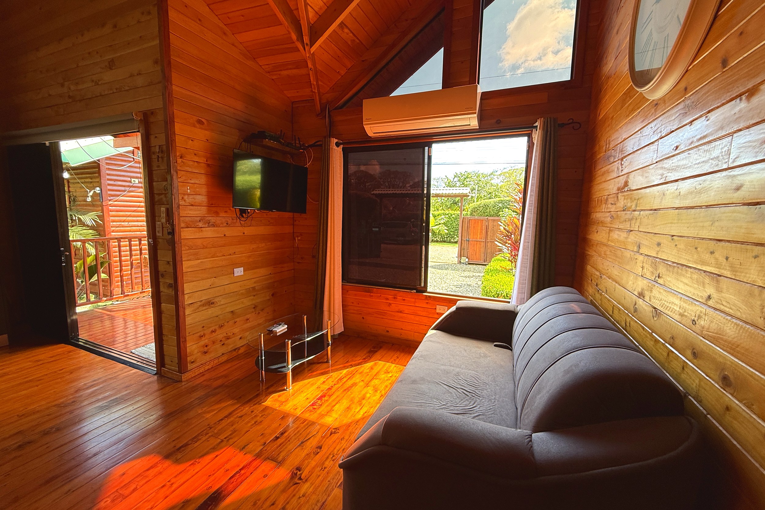 Wood-Paneled Living Room Unique Income Producing Home wood-paneled living room with sofa in Bahia, Costa Rica.