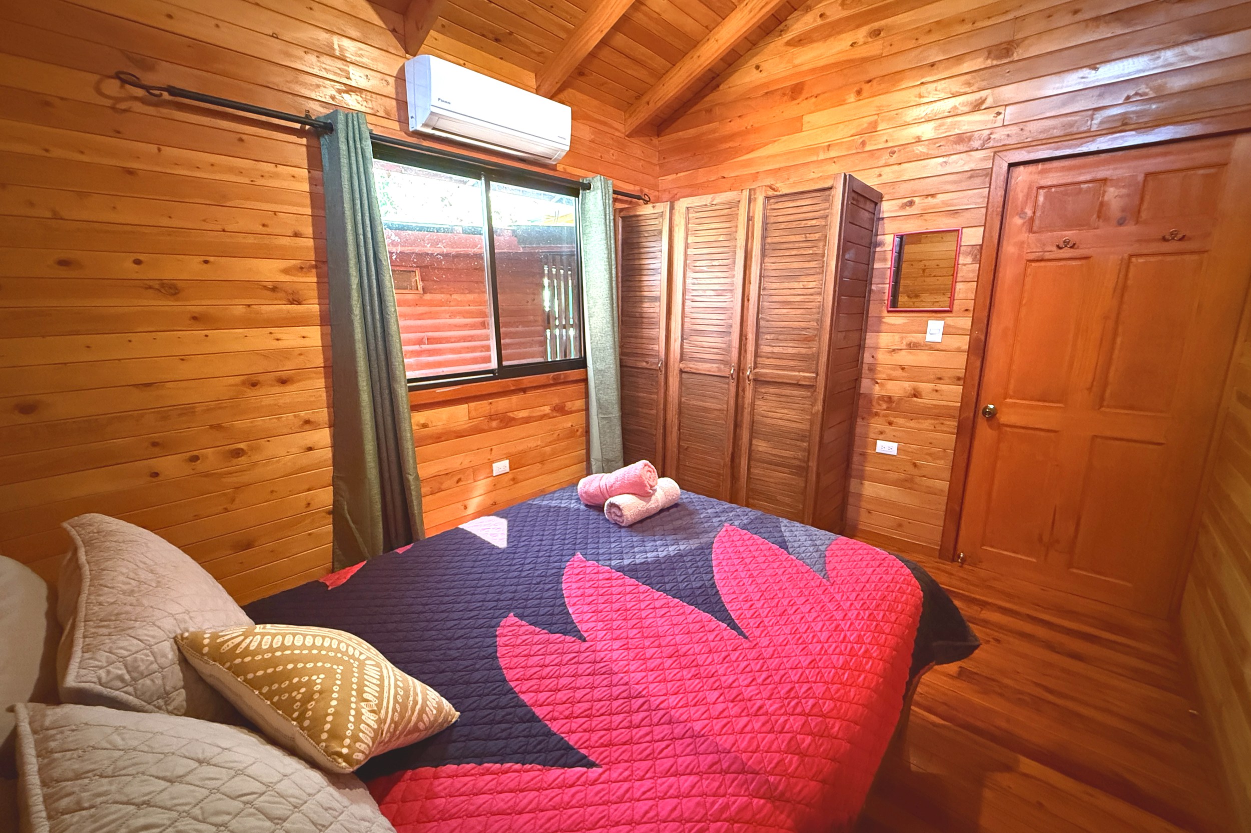 Cozy Cabin Bedroom Income Producing Home and Cabin wooden bedroom with bed in Bahia, Costa Rica