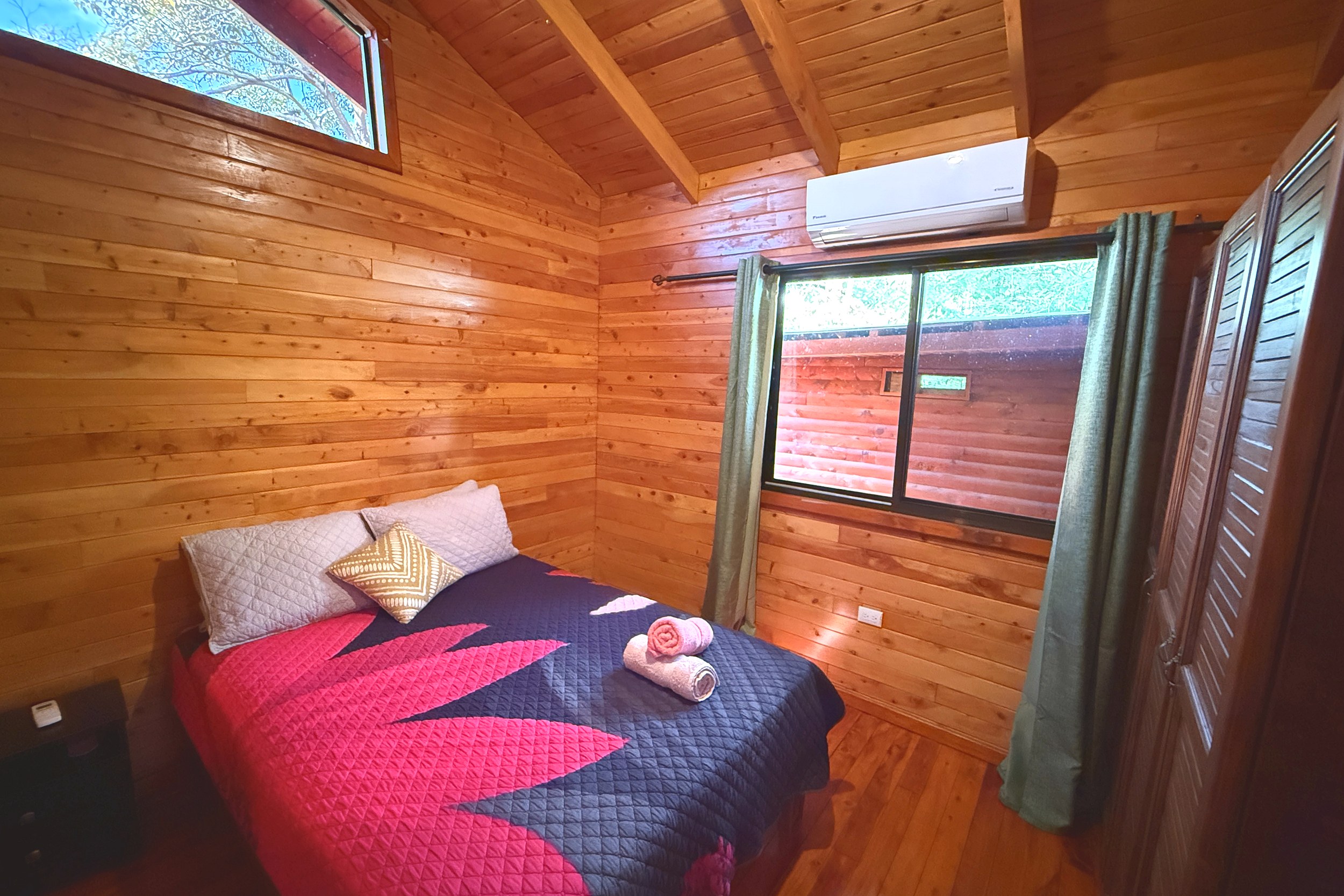 Cozy Cabin Bedroom Unique Income Producing Home cabin bedroom with wood walls in Bahia, Costa Rica