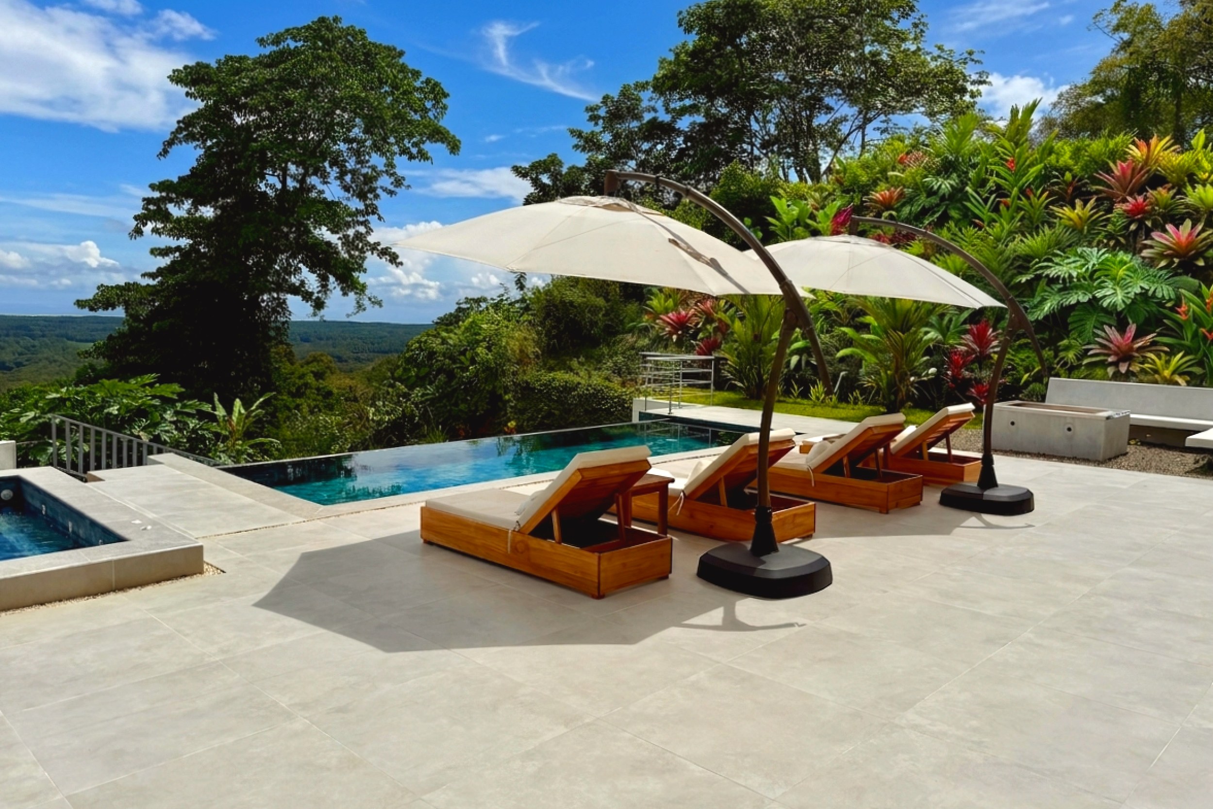 Tropical Luxury Villa infinity pool deck with sun loungers in Costa Rica