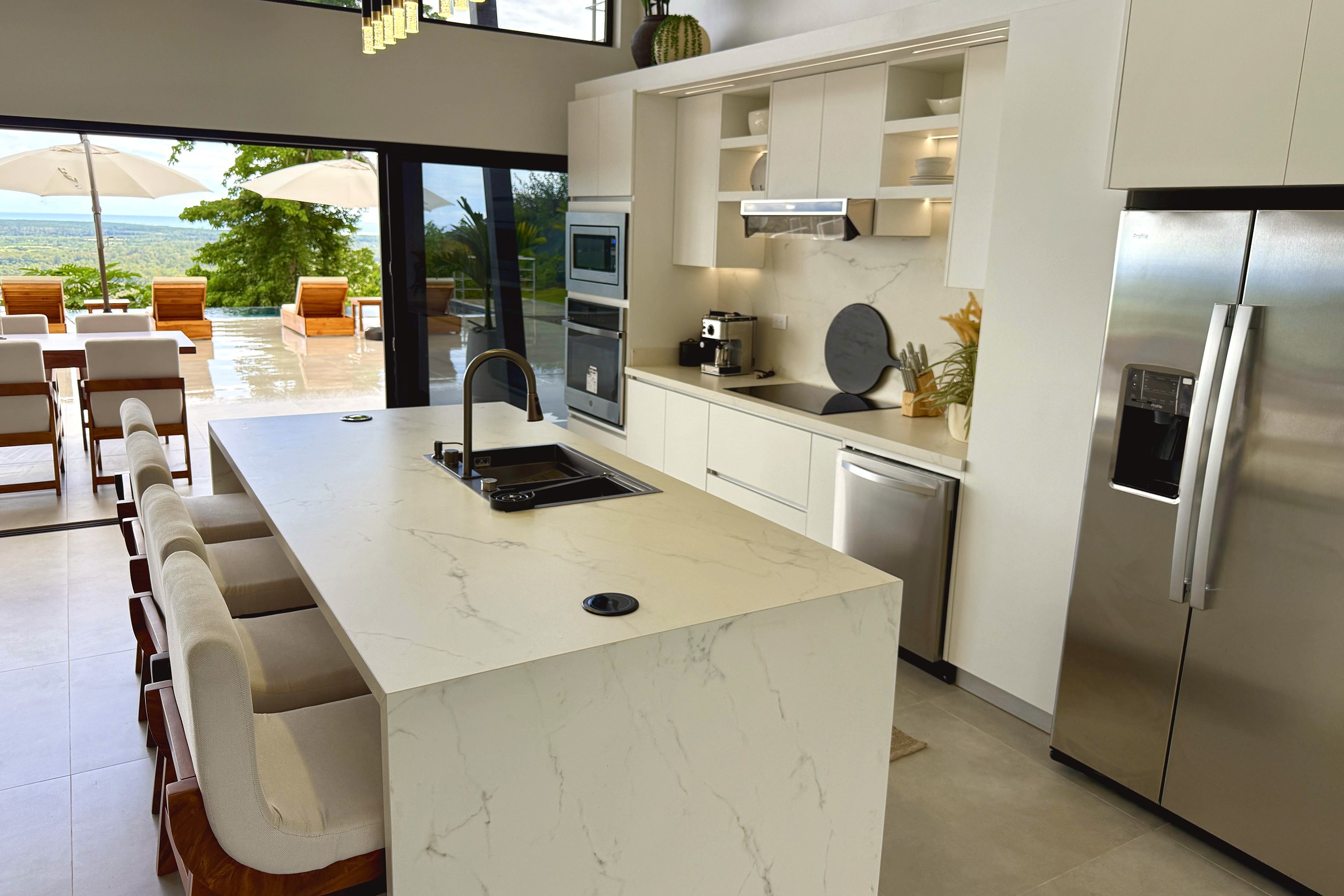 Modern Luxury 4-Bedroom Home white kitchen island and appliances in Chontales, Costa Rica.