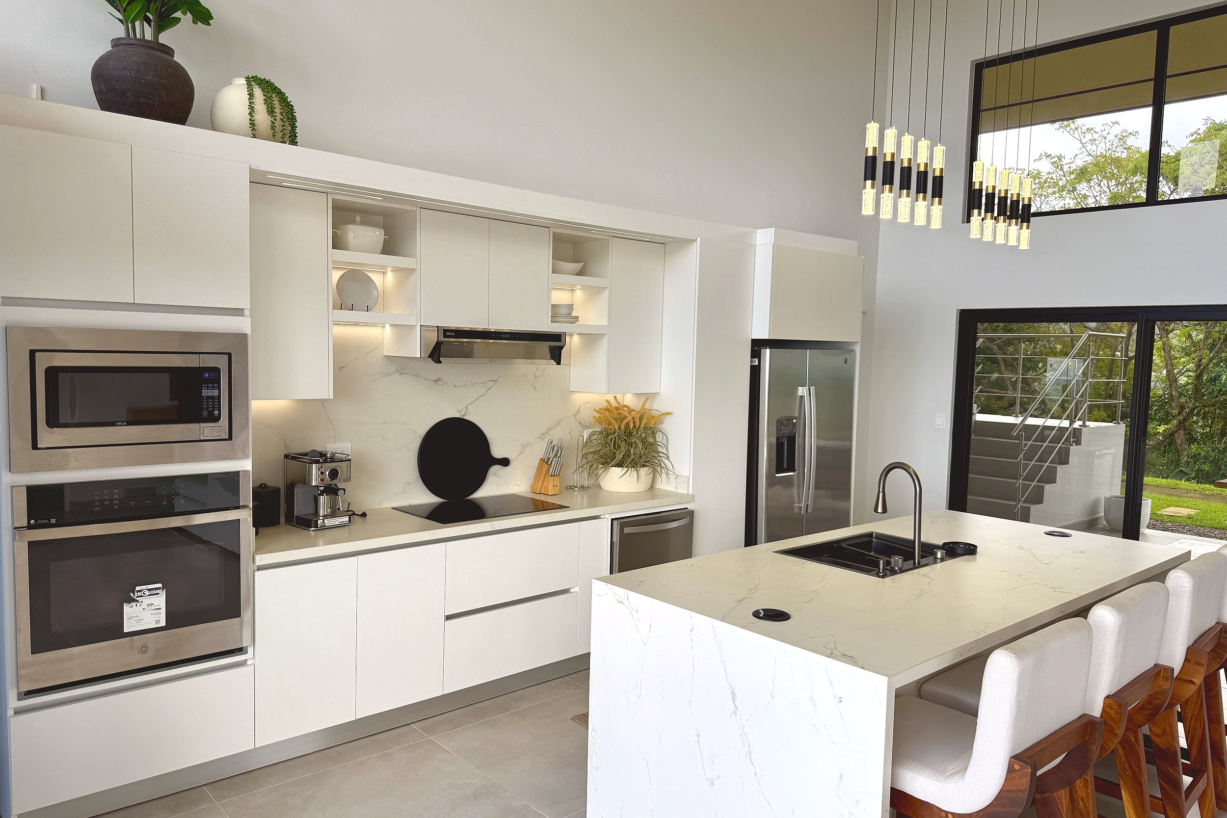Modern Luxury 4-Bedroom Home modern white kitchen with island in Chontales, Costa Rica.