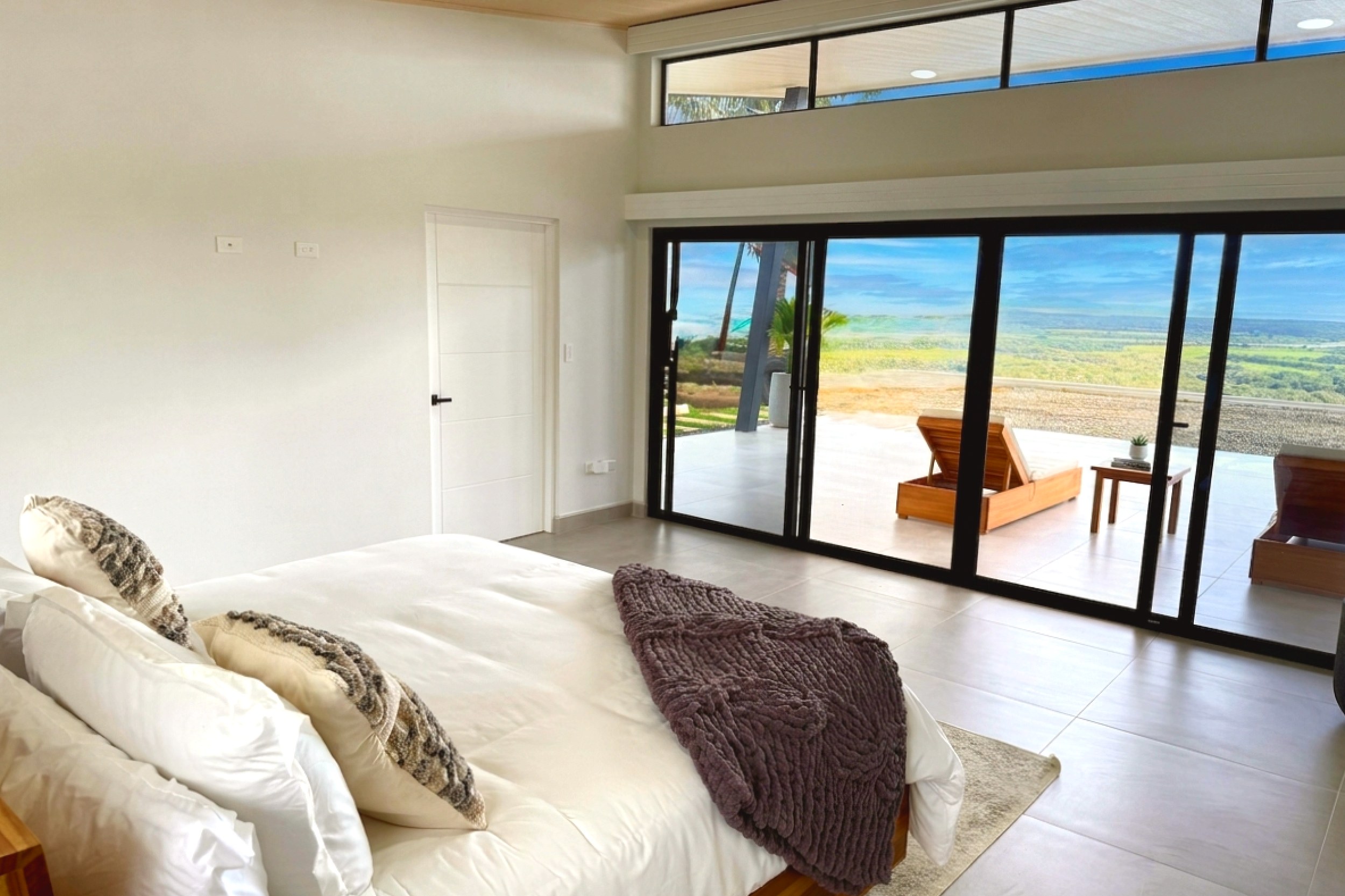 Modern Luxury 4-Bedroom Home master bedroom with ocean-view patio in Chontales, Costa Rica