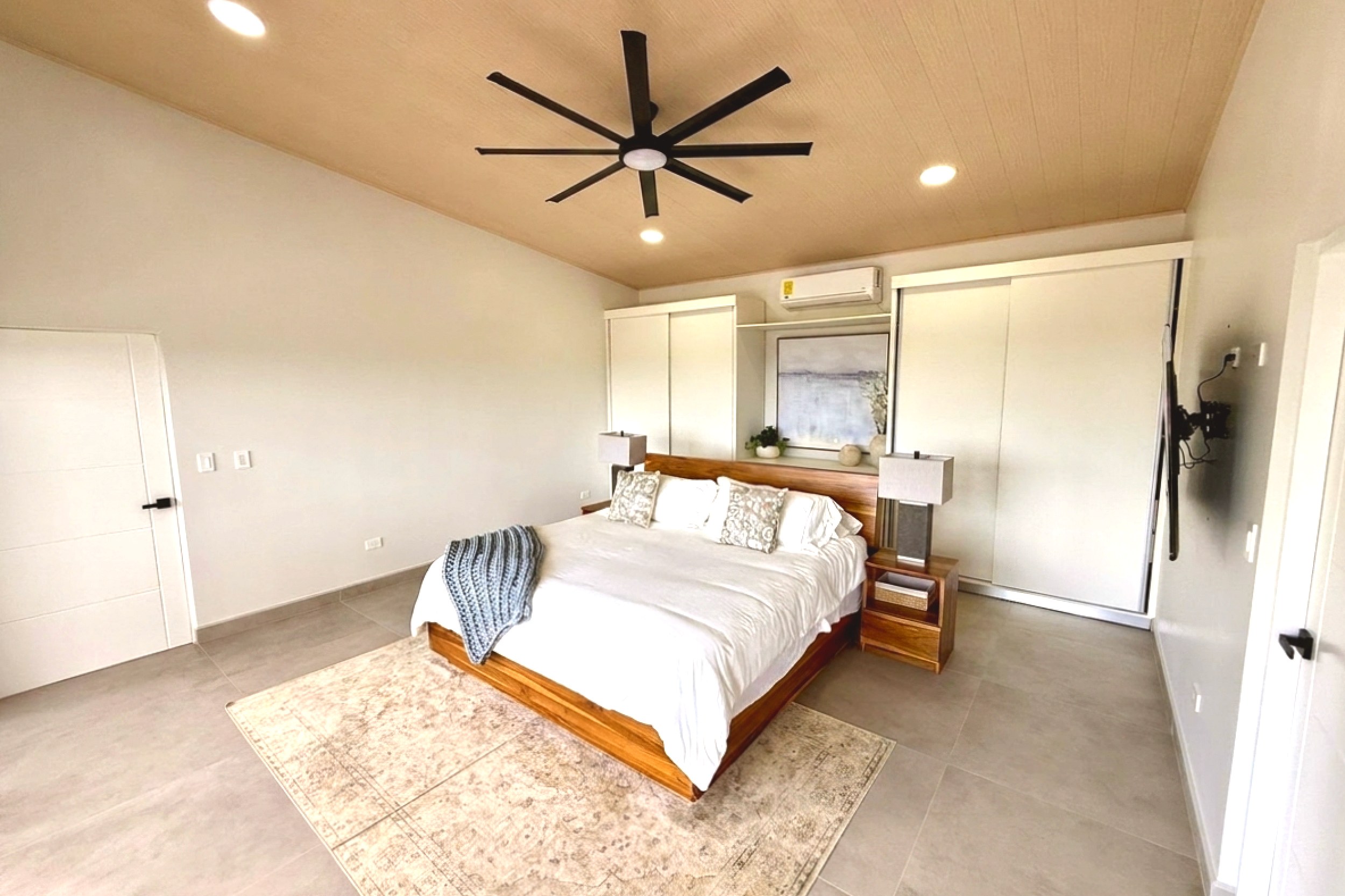 Modern Luxury 4-Bedroom Home main guest bedroom with king bed in Chontales, Costa Rica.