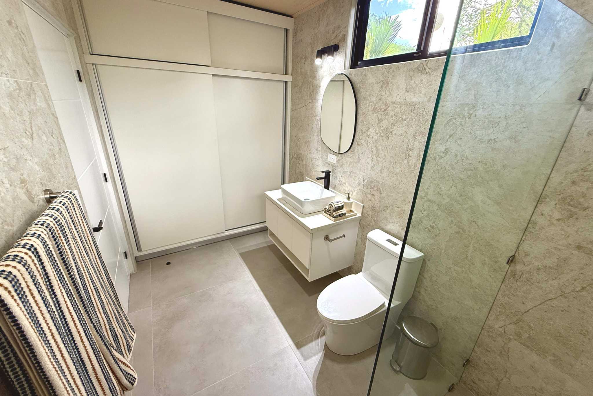 Modern Guest Bathroom Modern Luxury 4-Bedroom Home guest bathroom vanity and toilet in Chontales, Costa Rica