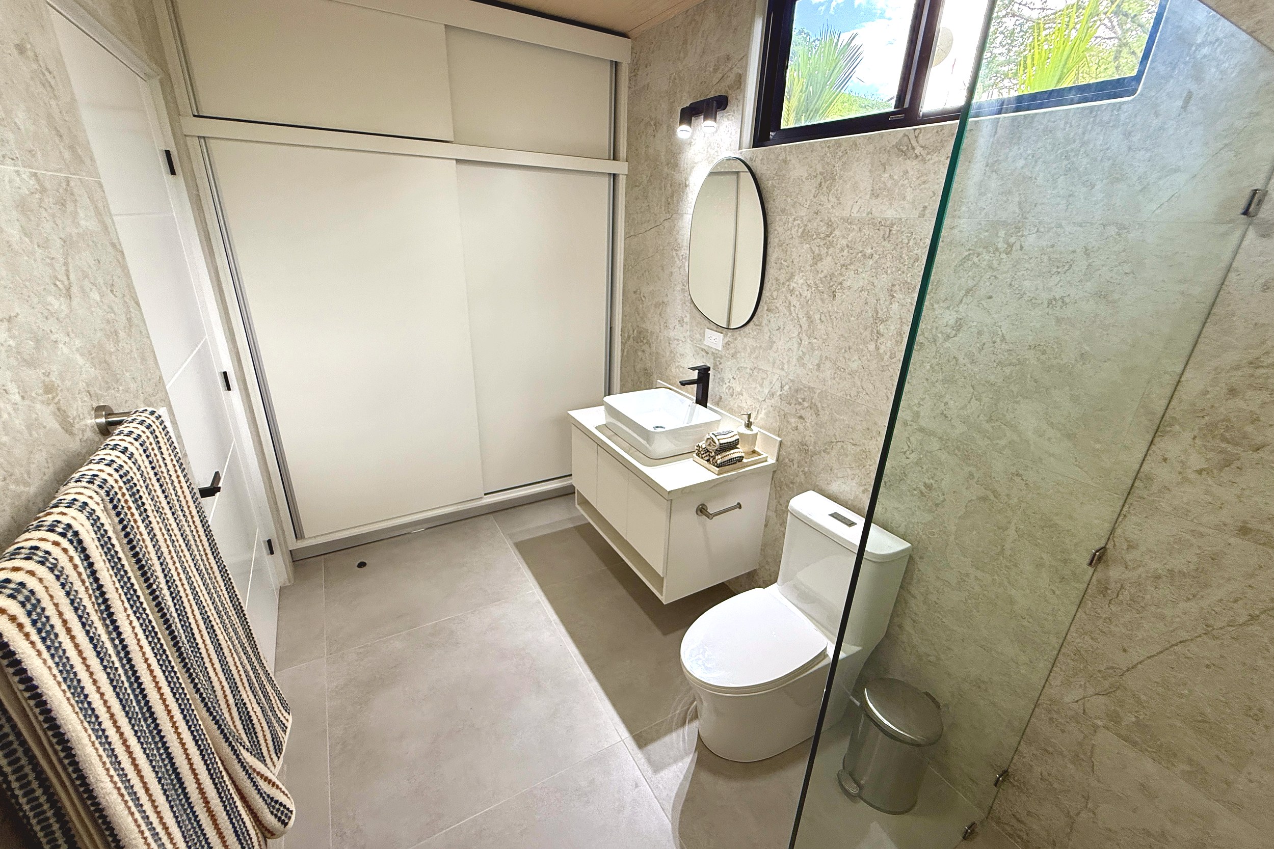 Modern Luxury 4-Bedroom Home guest bathroom vanity and toilet in Chontales, Costa Rica