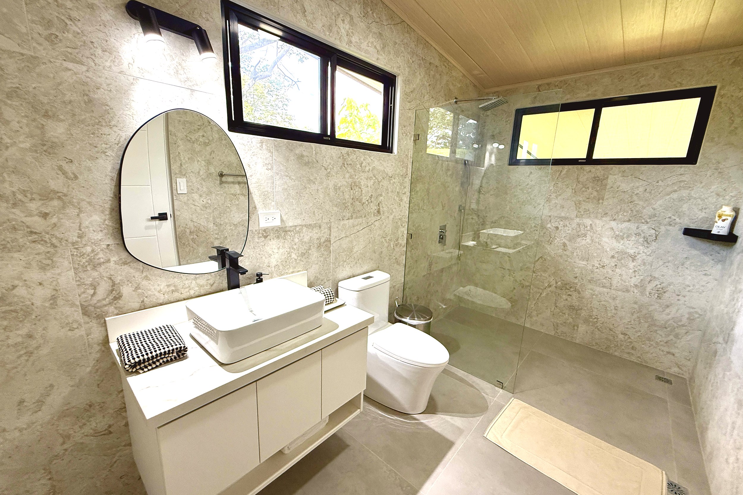 Modern Luxury 4-Bedroom Home guest bathroom vanity and shower in Chontales, Costa Rica