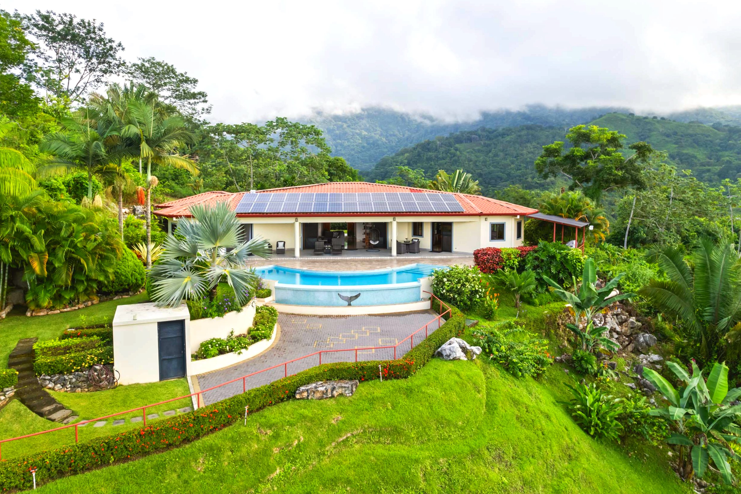 Luxurious Outdoor Living Home aerial view of villa, solar panels, and pool in Chontales, Costa Rica