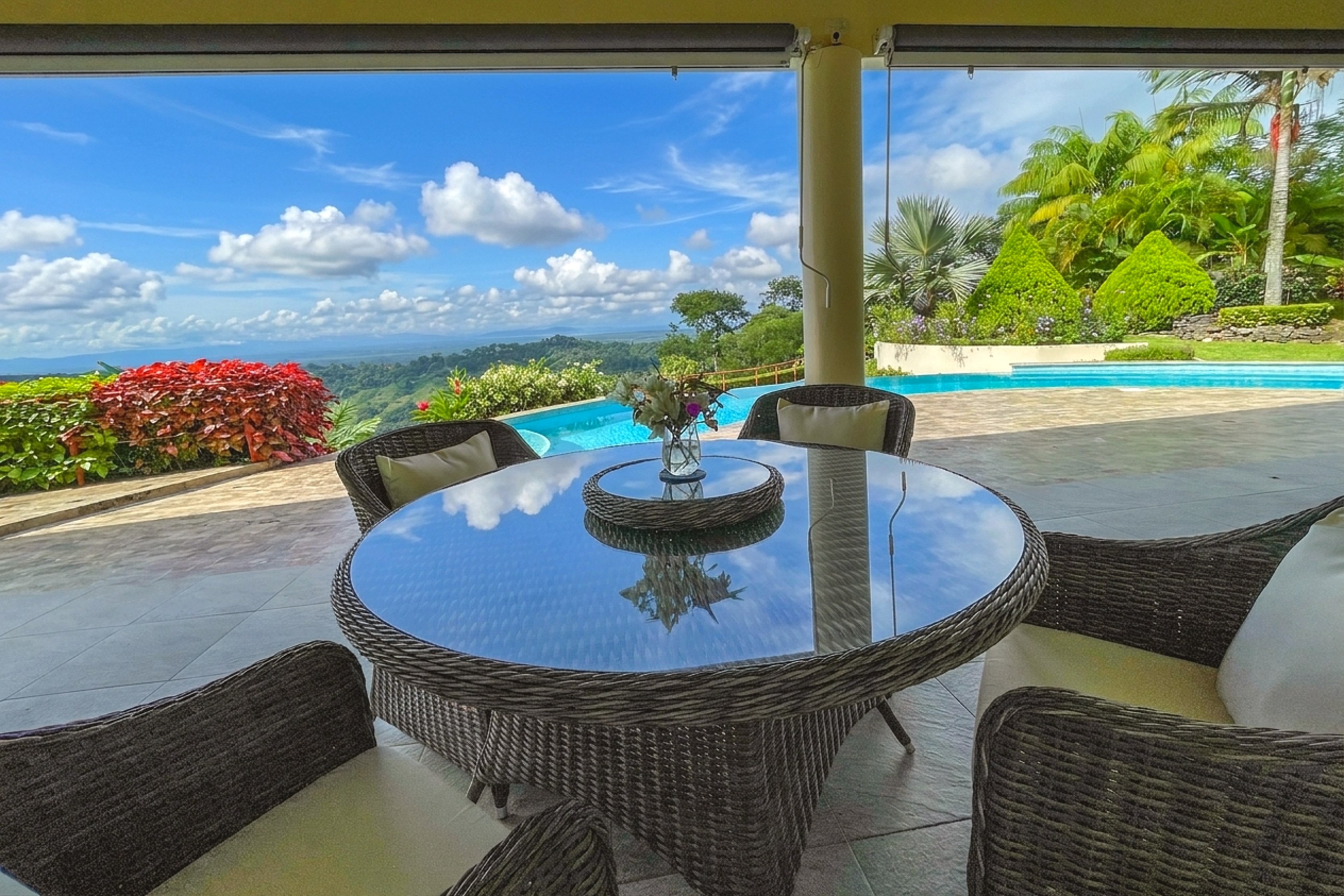 Luxurious Panoramic View Home terrace dining table and pool in Chontales, Costa Rica