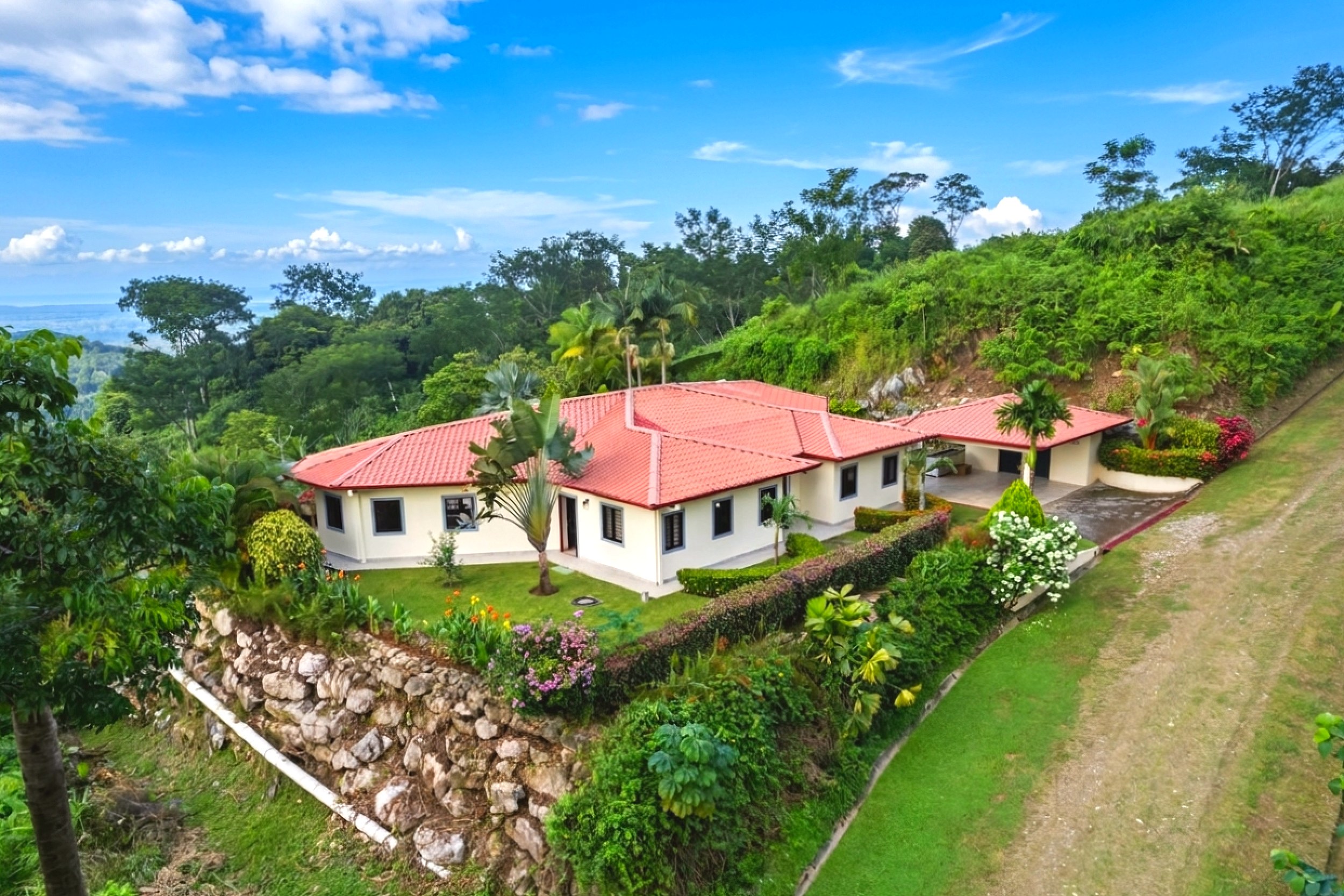 Luxurious Ocean View Home aerial view of red roof villa with lush gardens in Chontales, Costa Rica