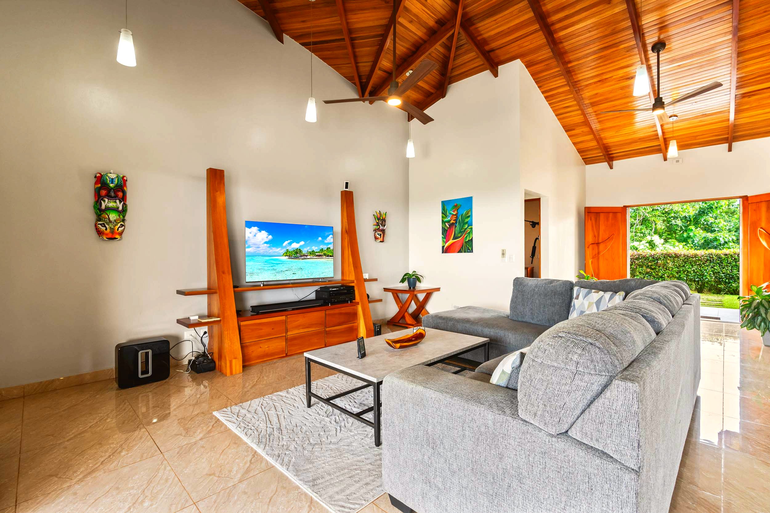 Luxurious Modern Home living room with grey sectional and wood ceiling in Chontales, Costa Rica