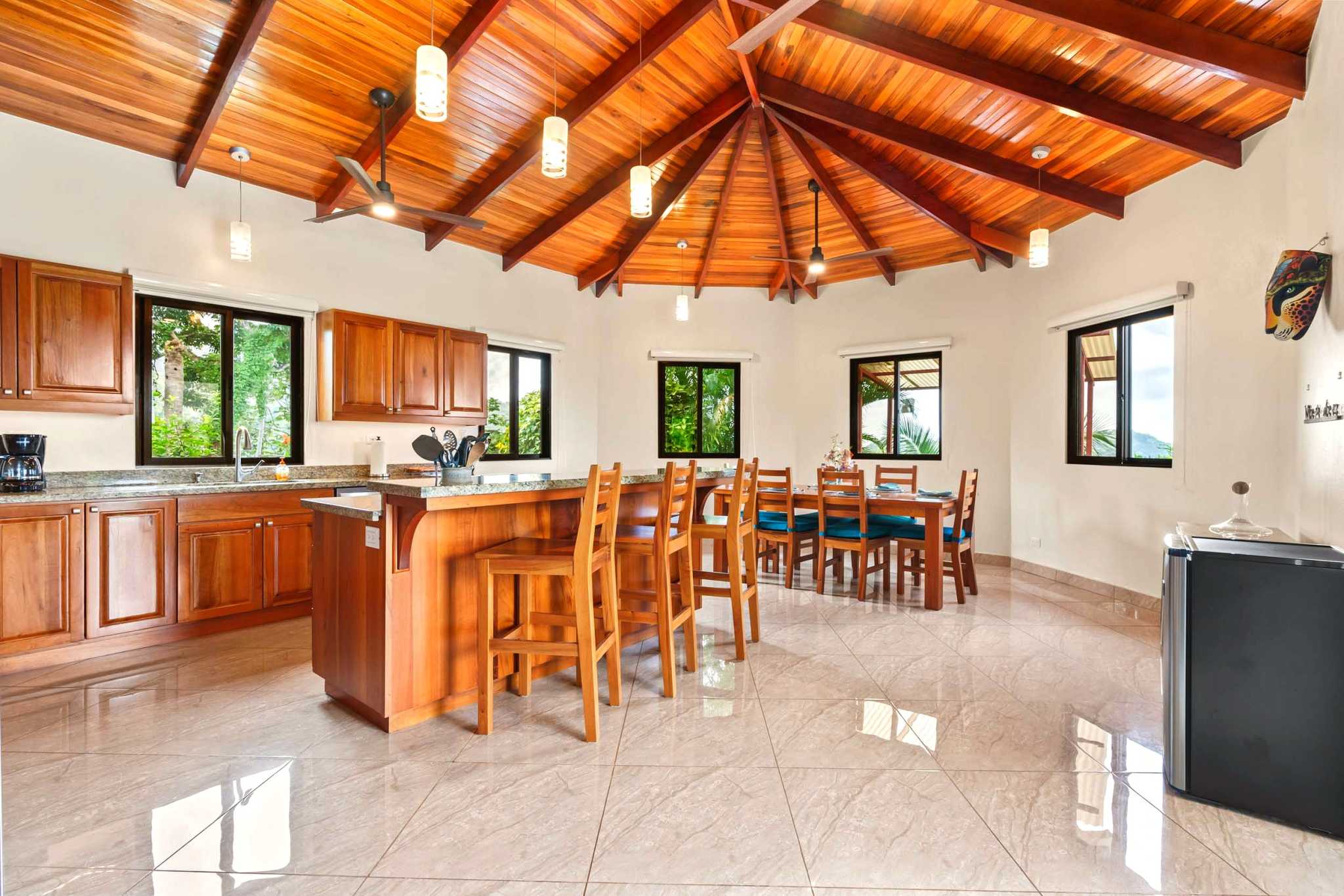 Spacious Kitchen & Dining Luxurious Ocean View Home kitchen with wood ceiling and island in Chontales, Costa Rica.
