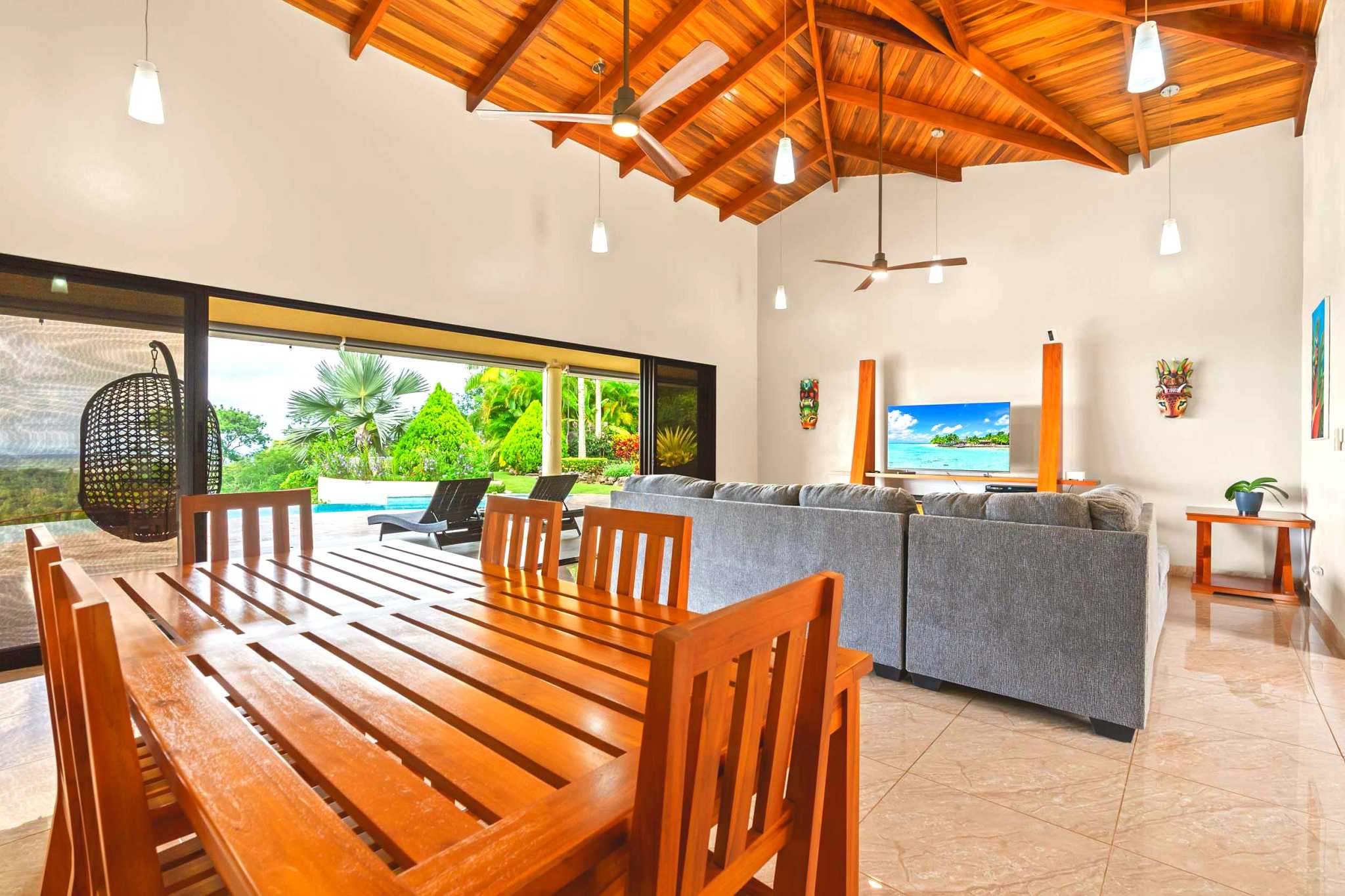 Main Dining & Living Area Luxurious Ocean View Home wooden dining table and vaulted wood ceiling in Chontales, Costa Rica