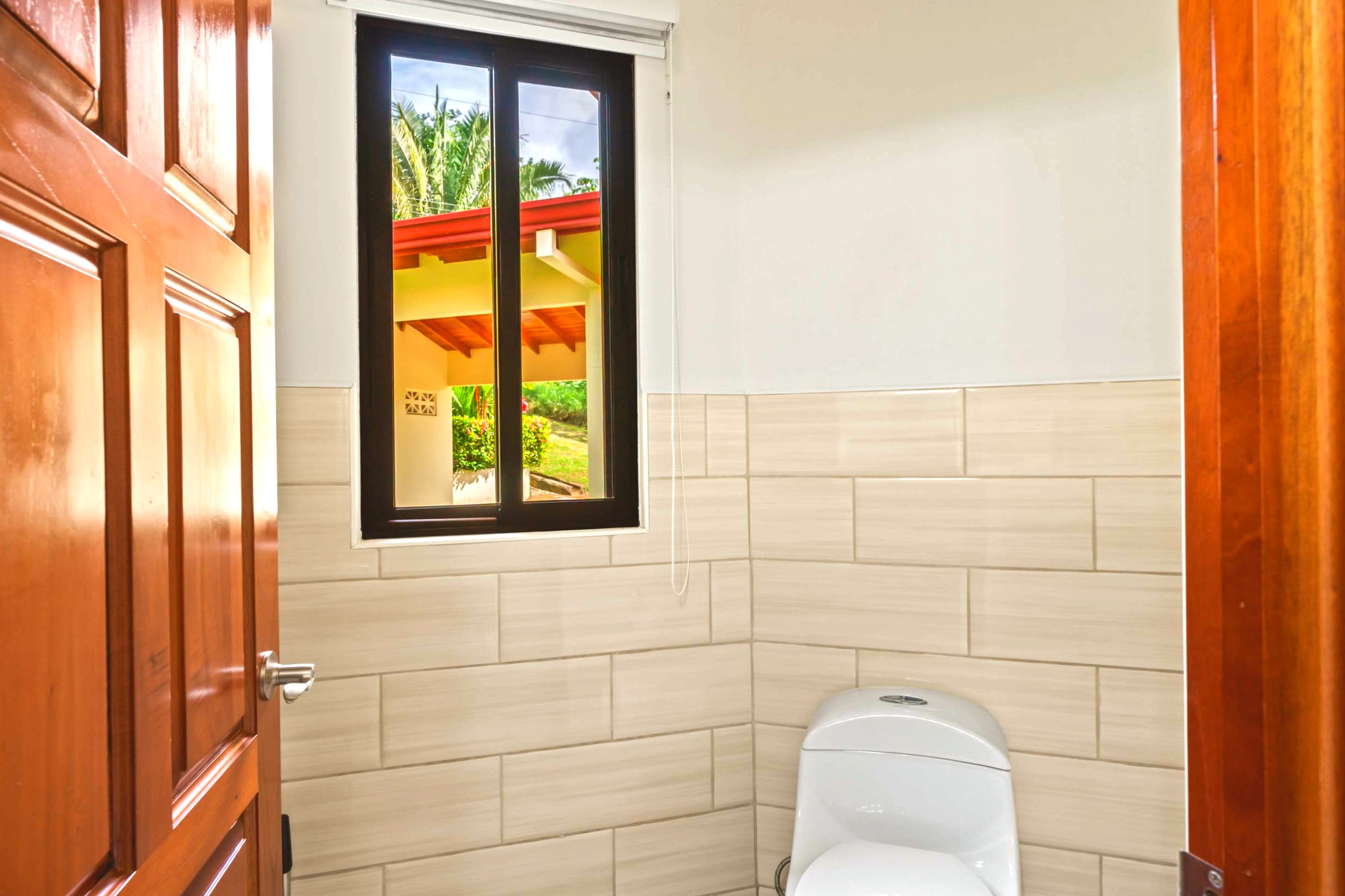 Luxurious Home guest bathroom toilet and window in Chontales, Costa Rica