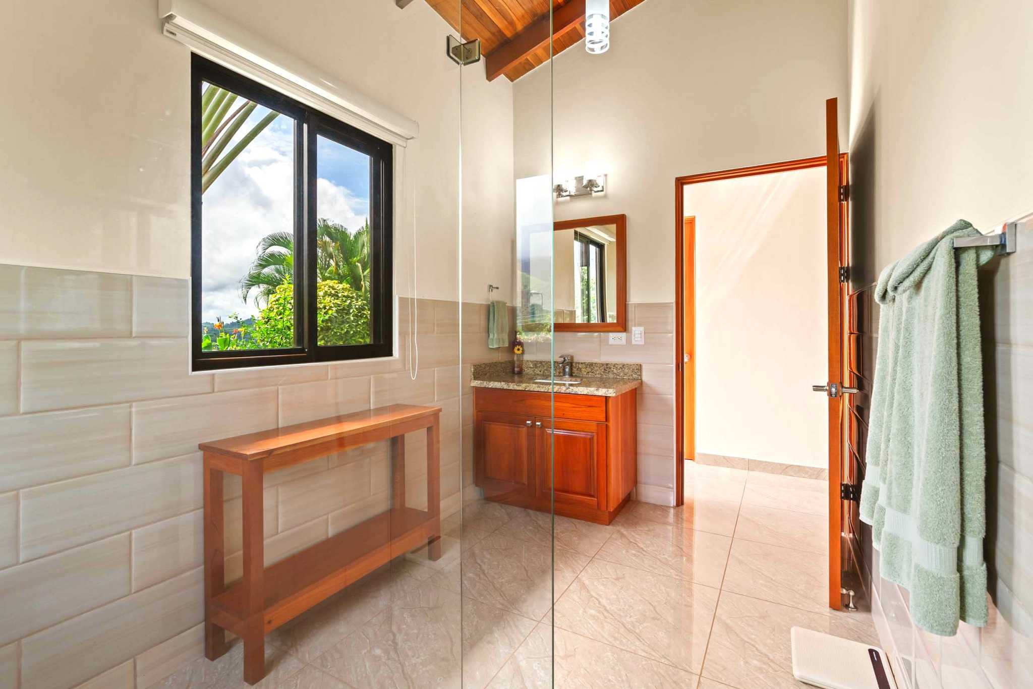 Main Guest Bathroom Luxurious Ocean View Home guest bathroom with wood vanity in Chontales, Costa Rica.