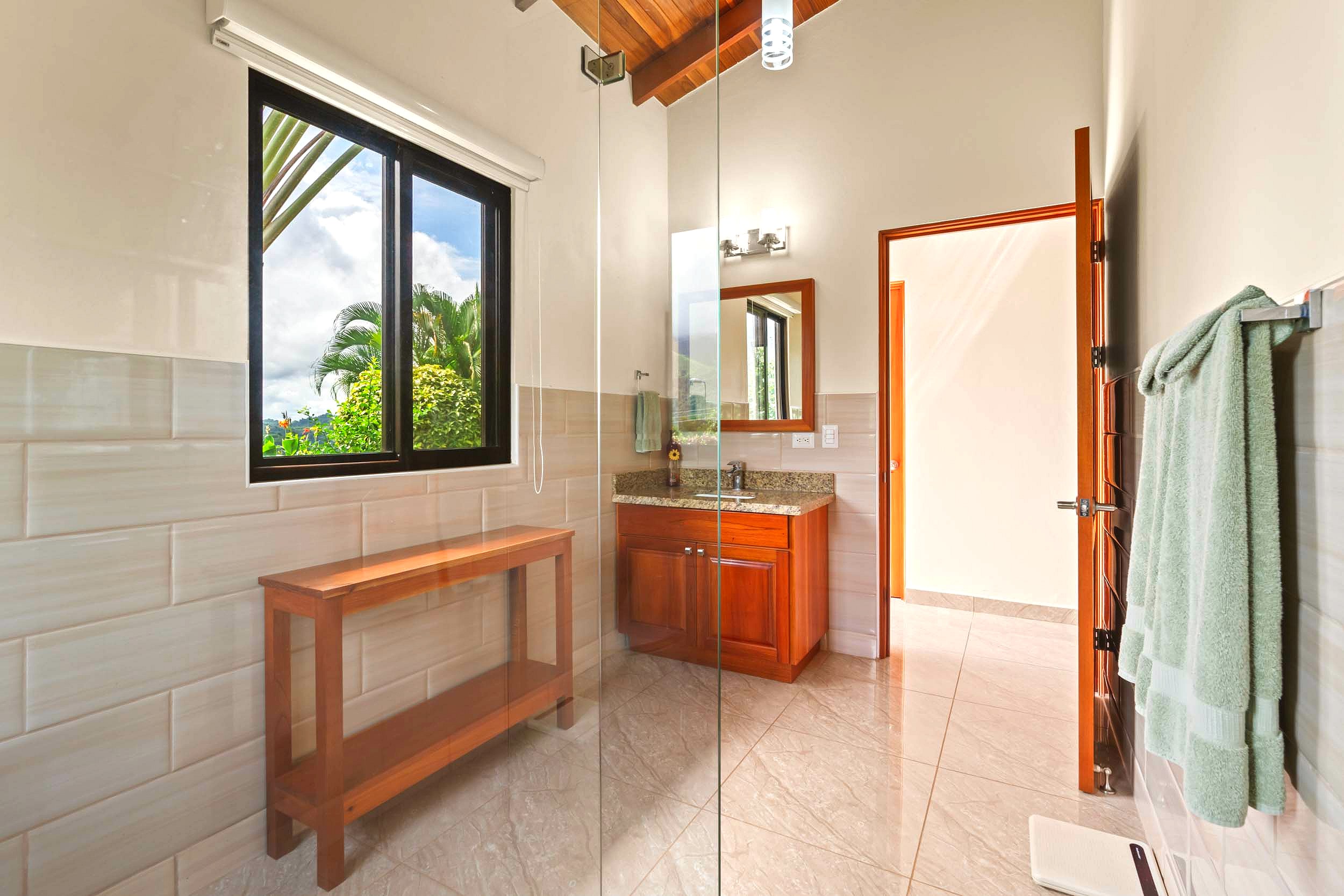 Luxurious Ocean View Home guest bathroom with wood vanity in Chontales, Costa Rica.