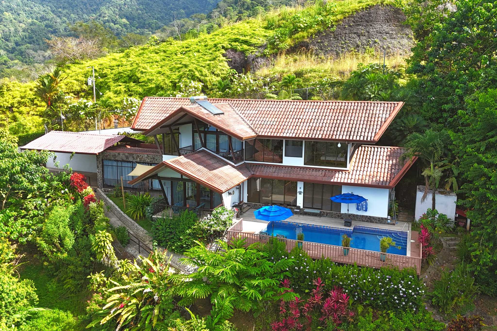 Panoramic Ocean View Home aerial view with pool, tropical hillside setting in Ojochal, Costa Rica.
