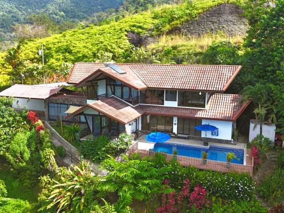 Panoramic Ocean View Home aerial view with pool, tropical hillside setting in Ojochal, Costa Rica.