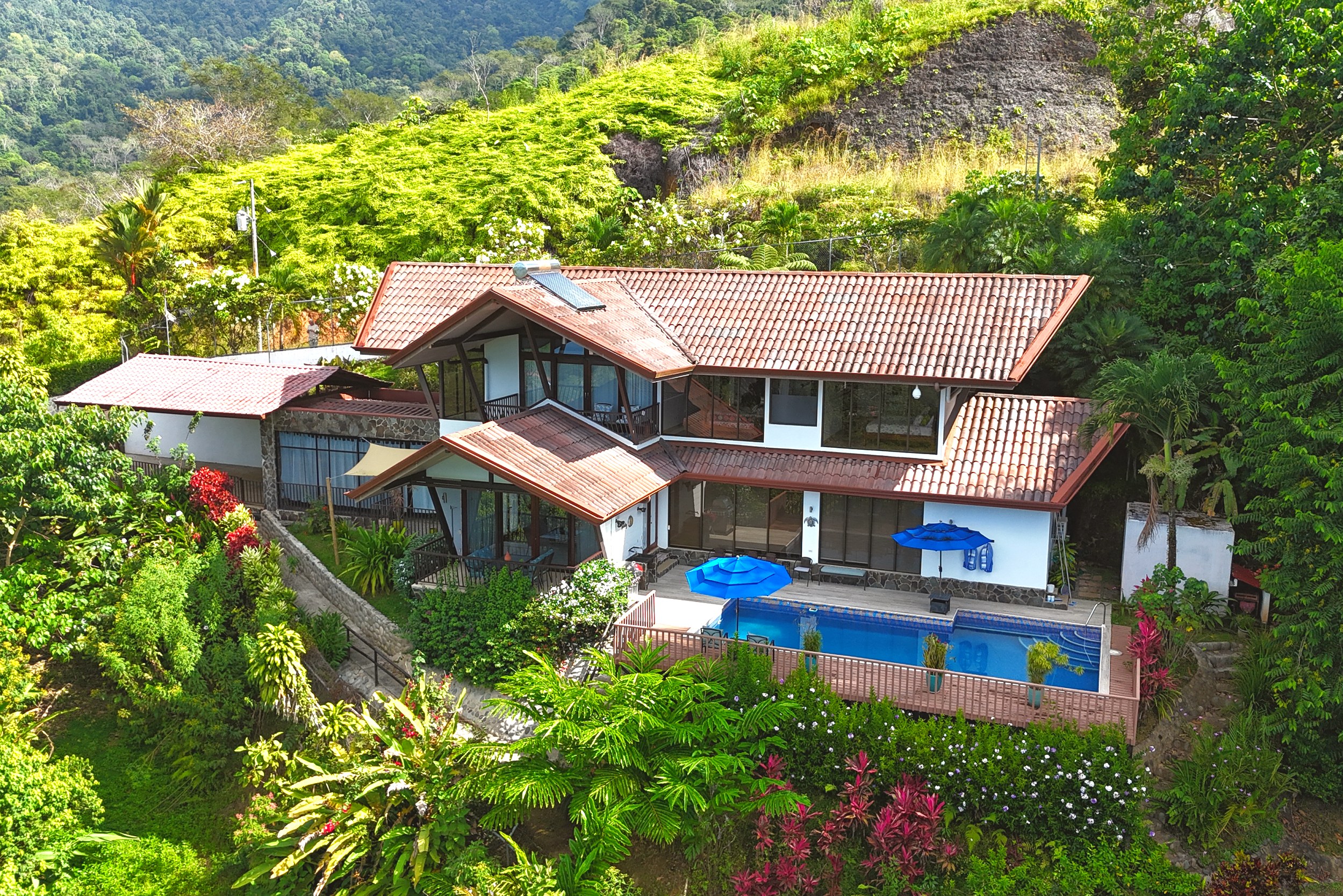 Panoramic Ocean View Home aerial view with pool, tropical hillside setting in Ojochal, Costa Rica.
