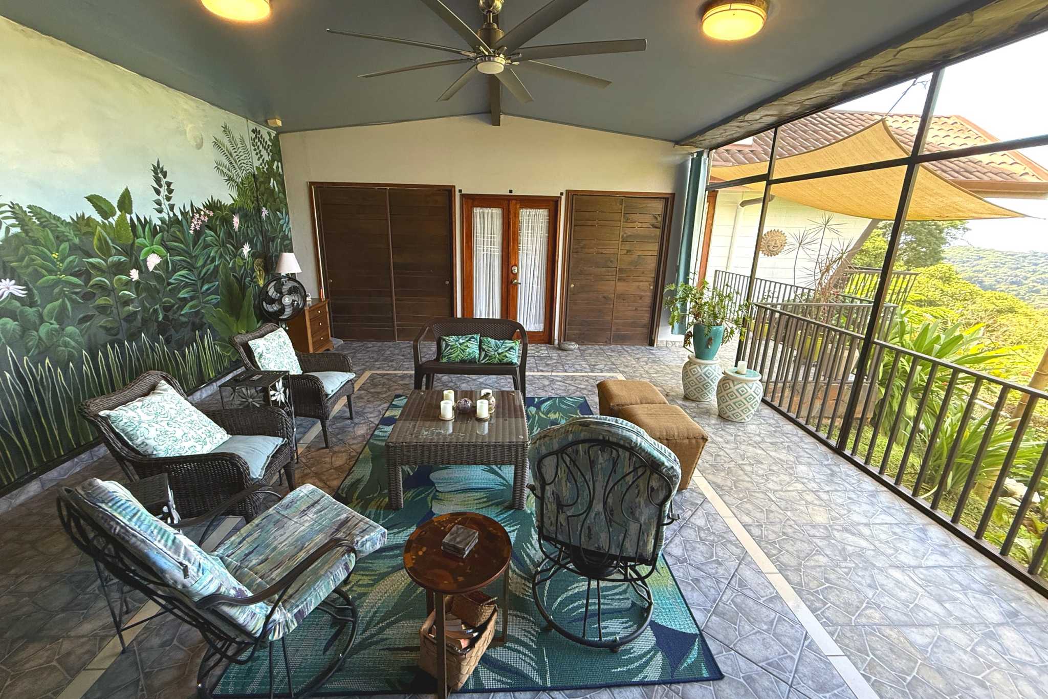 Panoramic Ocean View Home covered terrace with wicker lounge seating in Ojochal, Costa Rica
