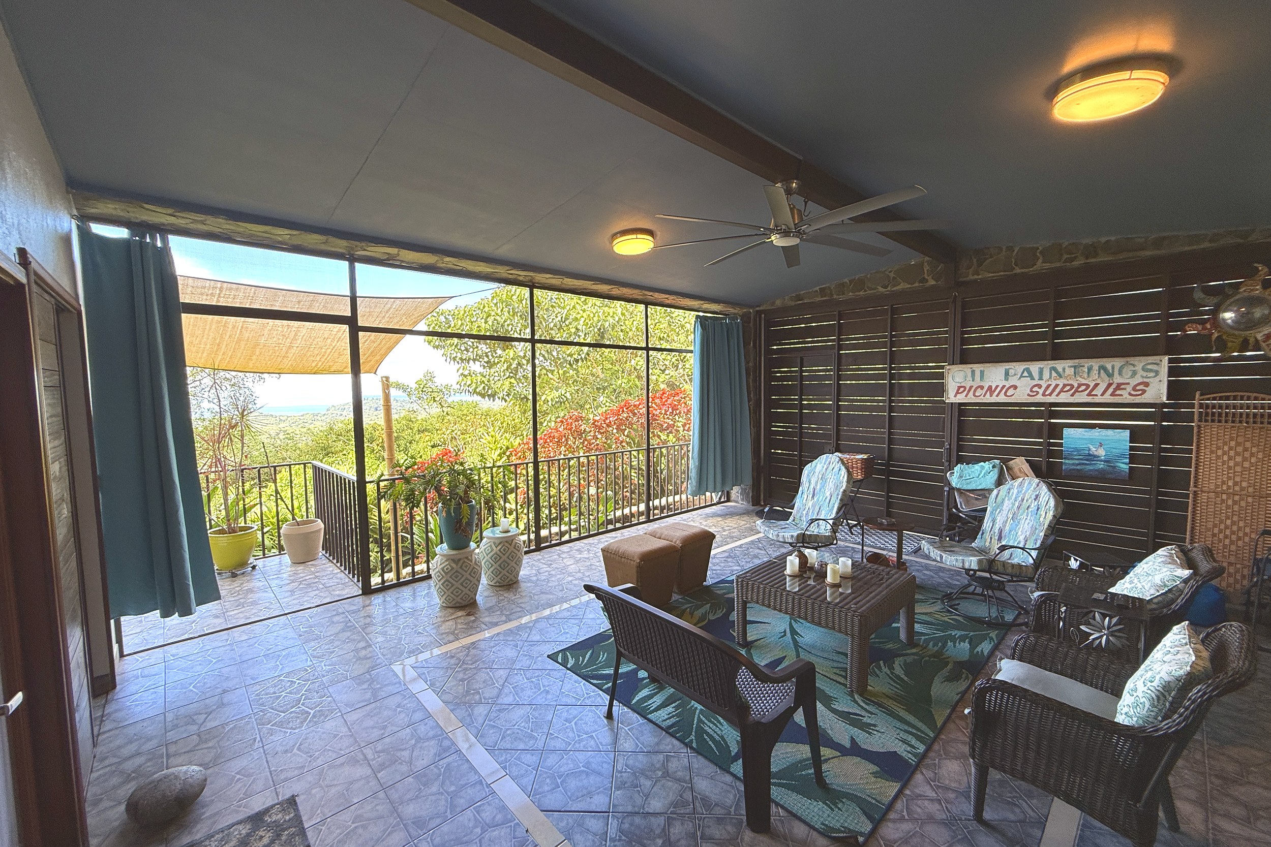 Covered Terrace Lounge Ocean View Home covered terrace with wicker seating and mountain views in Ojochal, Costa Rica