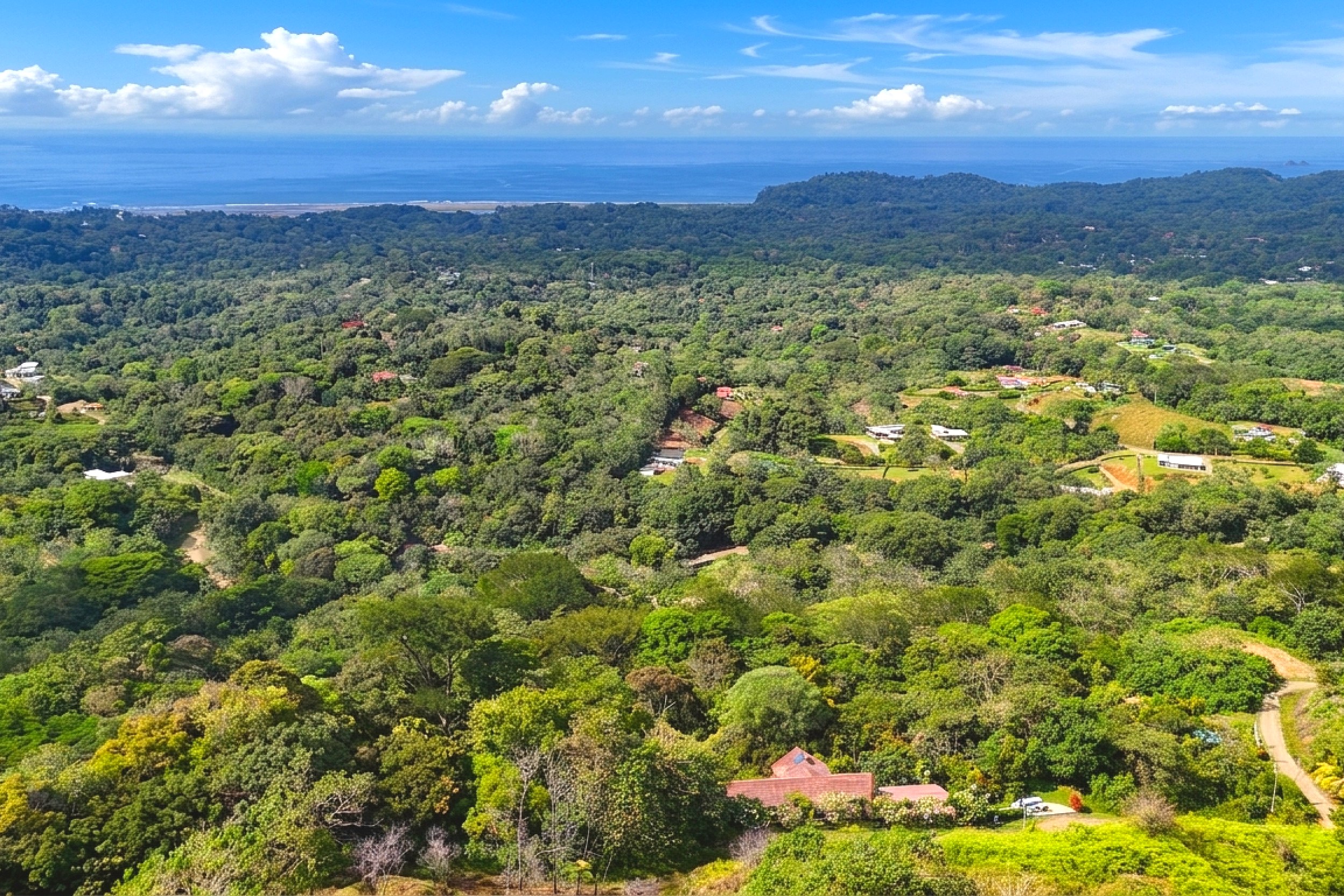 Panoramic Jungle & Ocean View Ocean View Home aerial view of lush jungle canopy and coastline in Ojochal, Costa Rica.