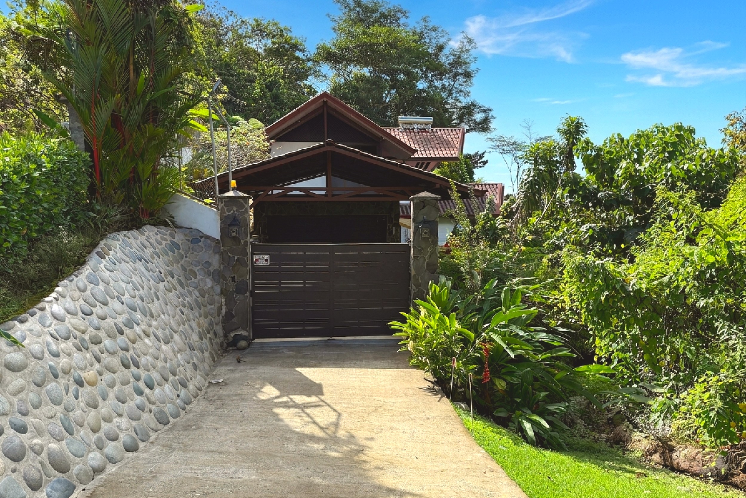 Gated Stone Entrance Driveway Panoramic Ocean View Home tropical gated driveway entrance in Ojochal, Costa Rica