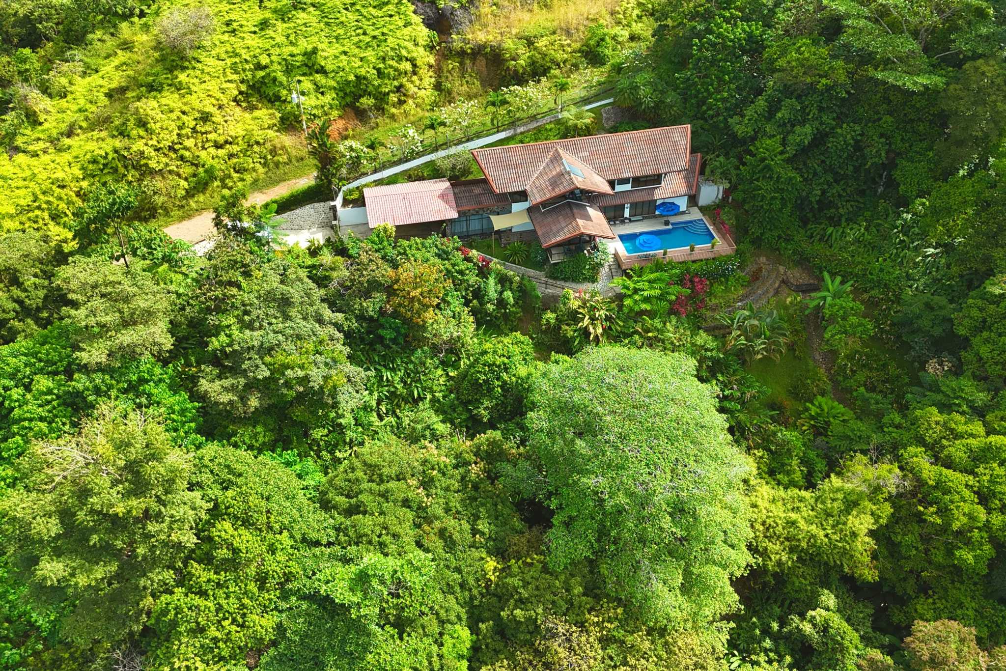 4-Bedroom Home aerial view with pool amid rainforest in Ojochal, Costa Rica
