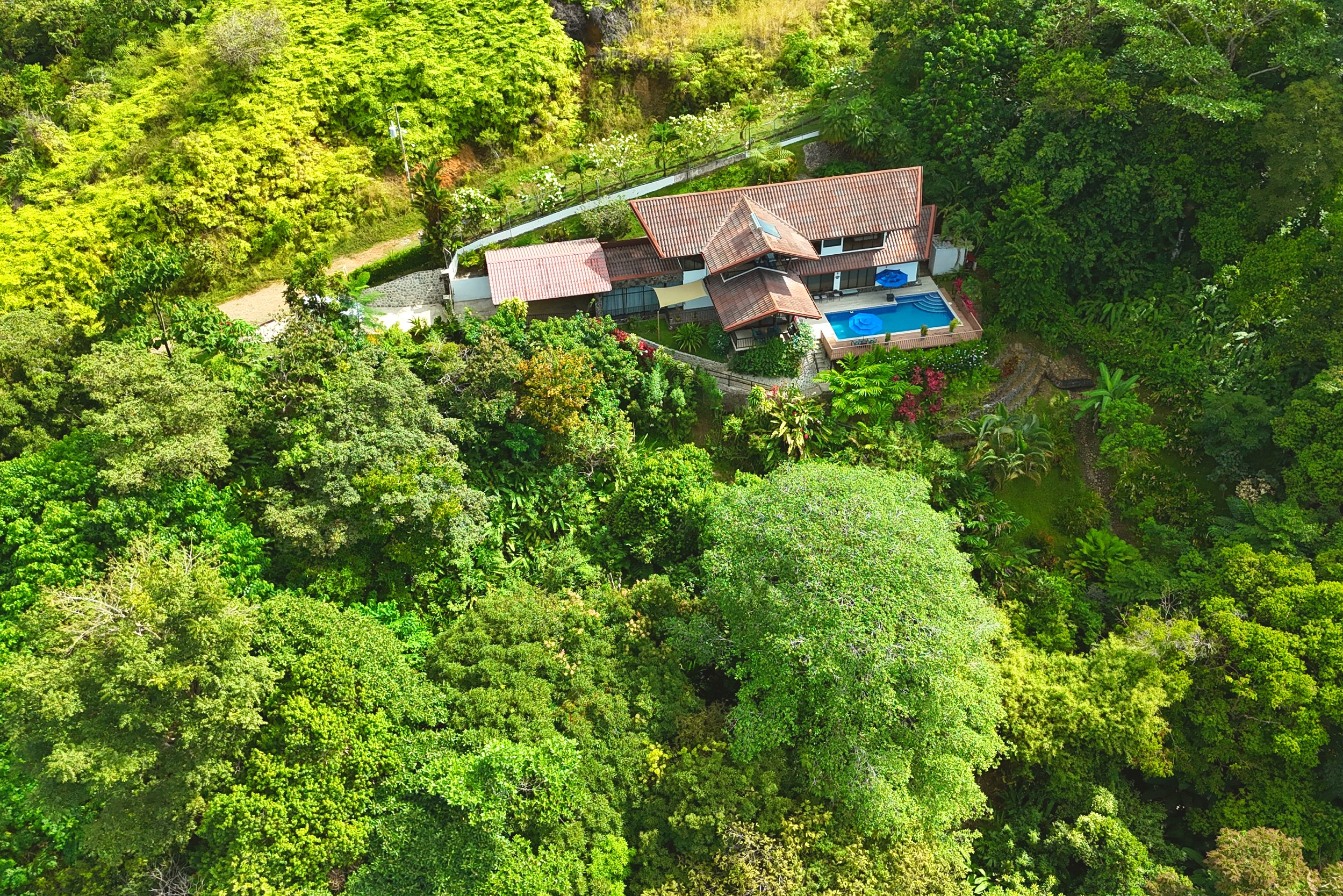 Aerial Jungle Estate View 4-Bedroom Home aerial view with pool amid rainforest in Ojochal, Costa Rica