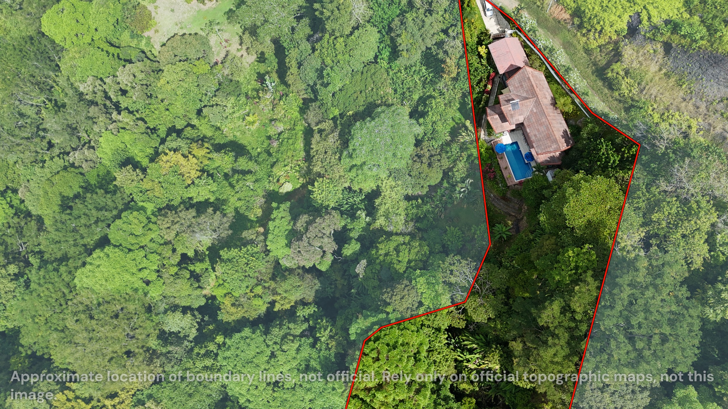 Aerial Jungle Property View Panoramic Ocean View Home aerial view with pool amid lush jungle in Ojochal, Costa Rica