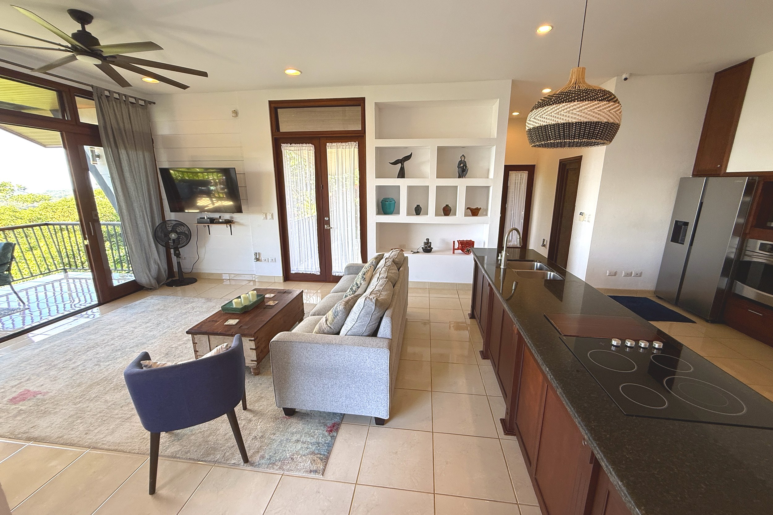 Living Room & Kitchen View Ocean View Home open living room with kitchen island in Ojochal, Costa Rica