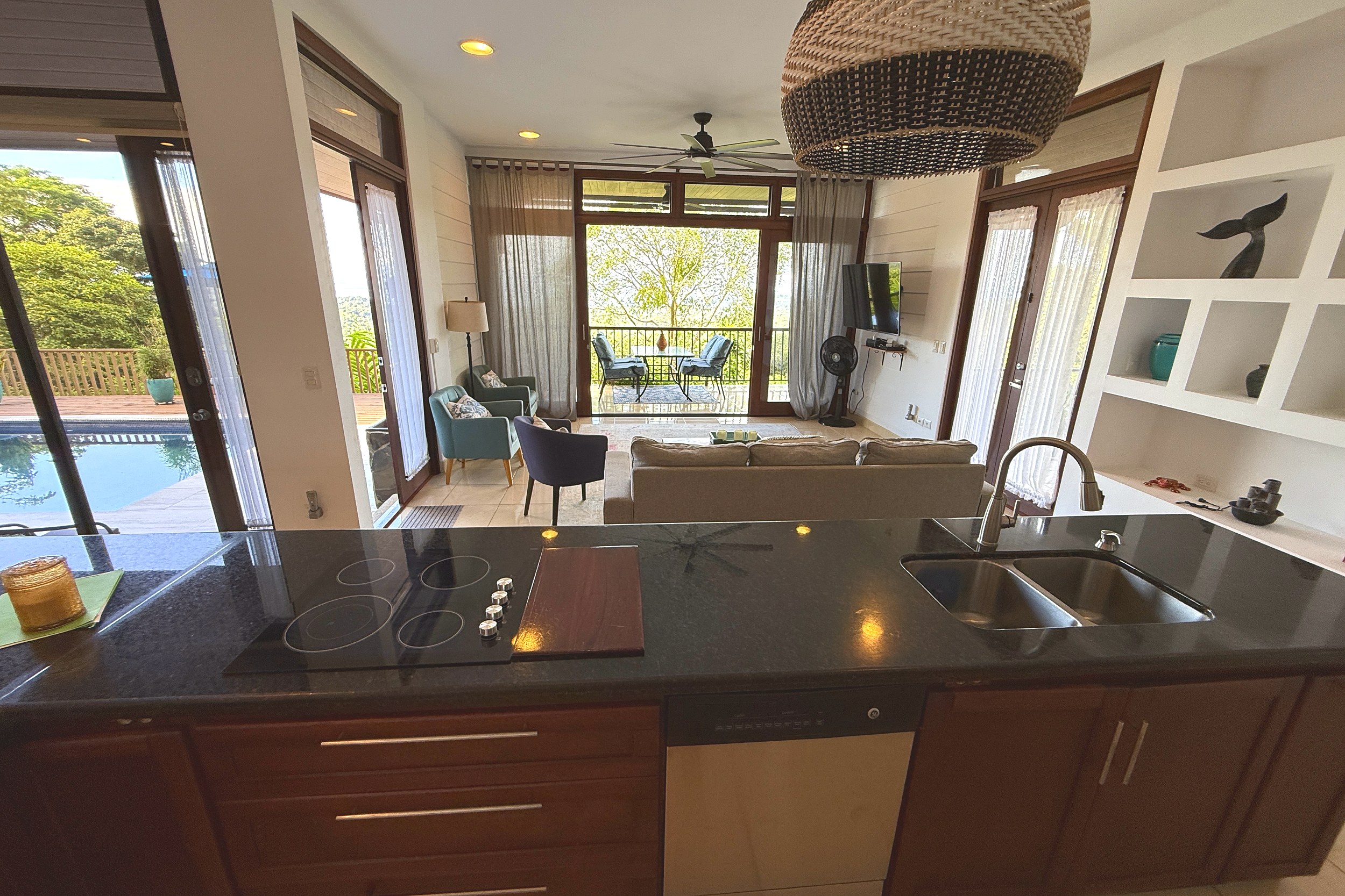 Kitchen with Pool View Panoramic Ocean View Home kitchen island with pool & living room view in Ojochal, Costa Rica